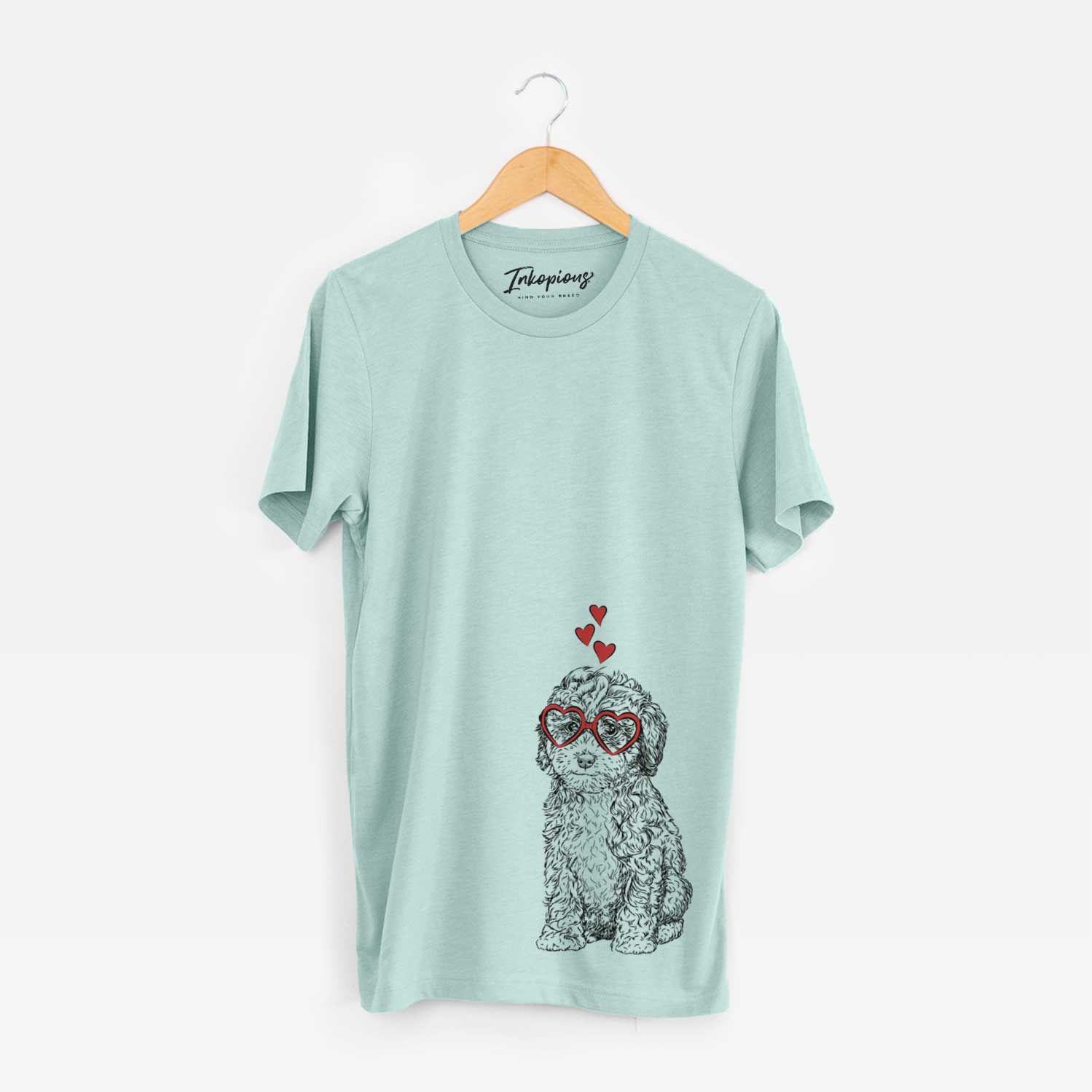 Hand-drawn sketch of Sweet Tea the Mini Doodle wearing heart-shaped glasses on a Heather Sage Unisex crewneck