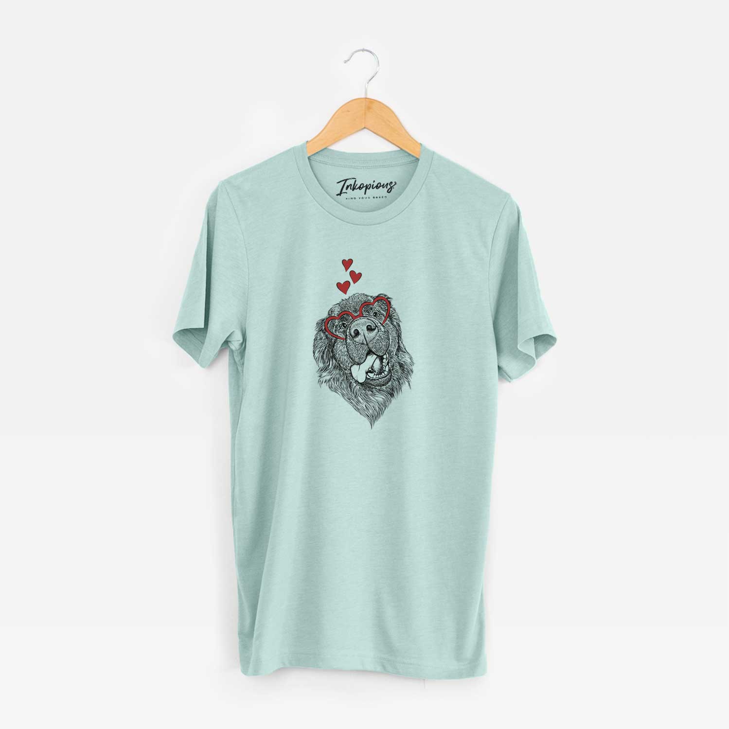 Hand-drawn sketch of Tuna the Newfoundland wearing heart-shaped glasses on a Heather Sage Unisex crewneck