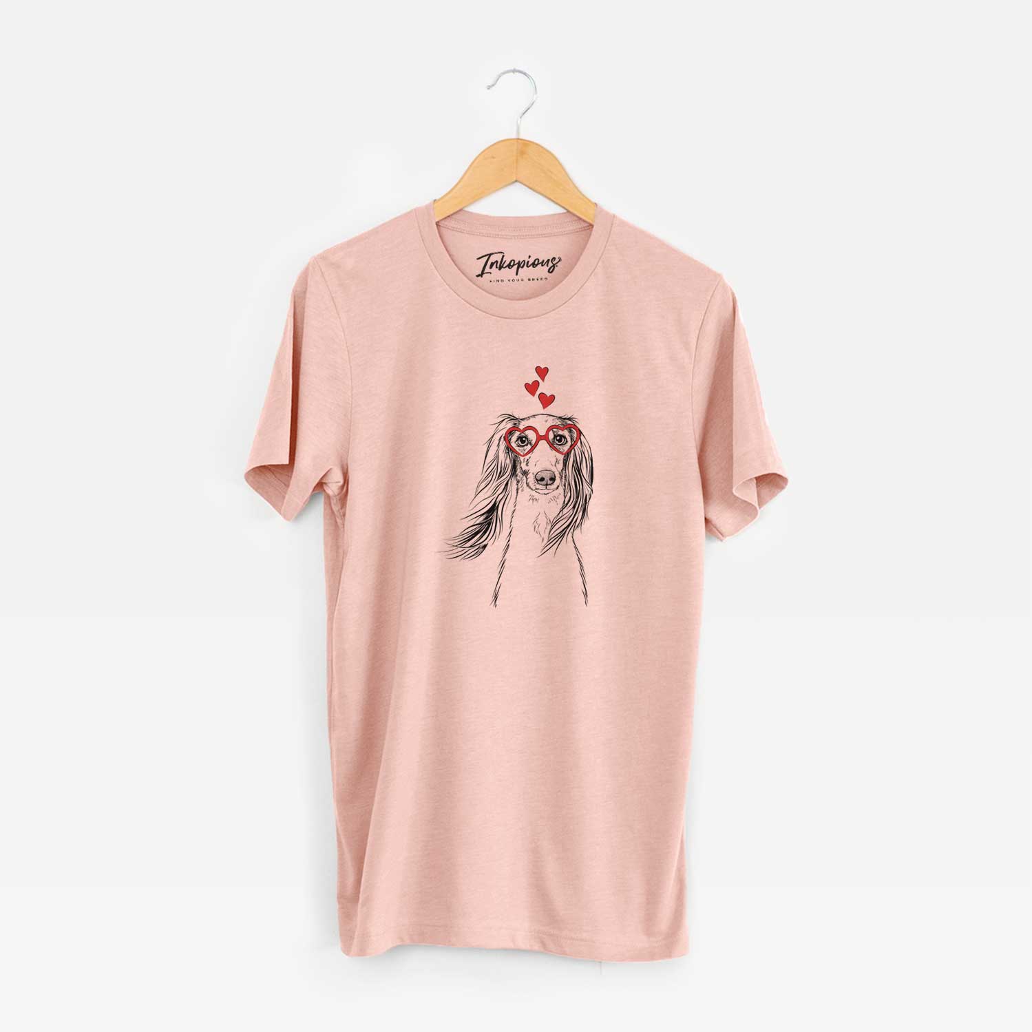 Hand-drawn sketch of Zahra the Saluki wearing heart-shaped glasses on a Peach Unisex crewneck
