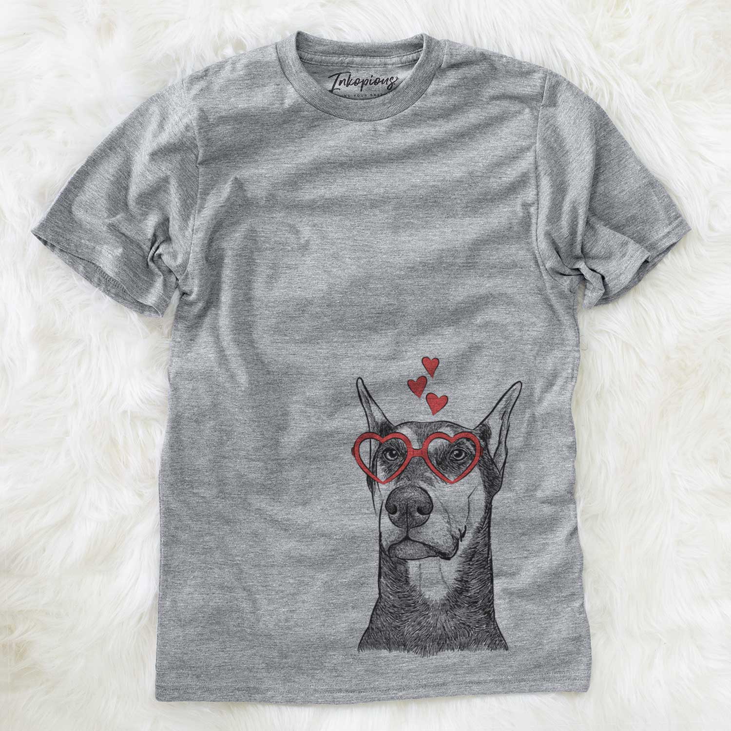 Hand-drawn sketch of Zeus the Doberman Pinscher wearing heart-shaped glasses on a Grey Unisex crewneck