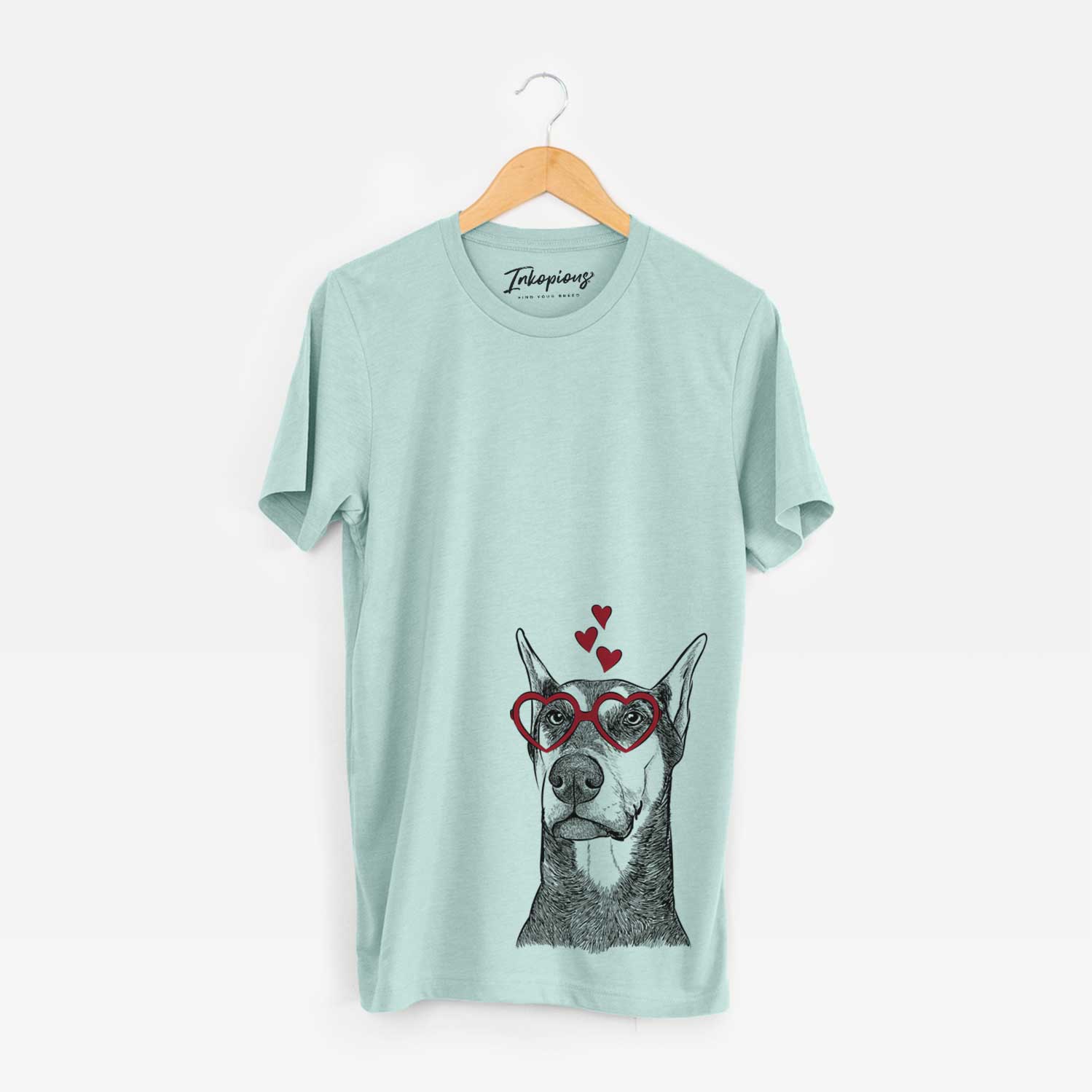 Hand-drawn sketch of Zeus the Doberman Pinscher wearing heart-shaped glasses on a Heather Sage Bella Canvas Unisex Crewneck