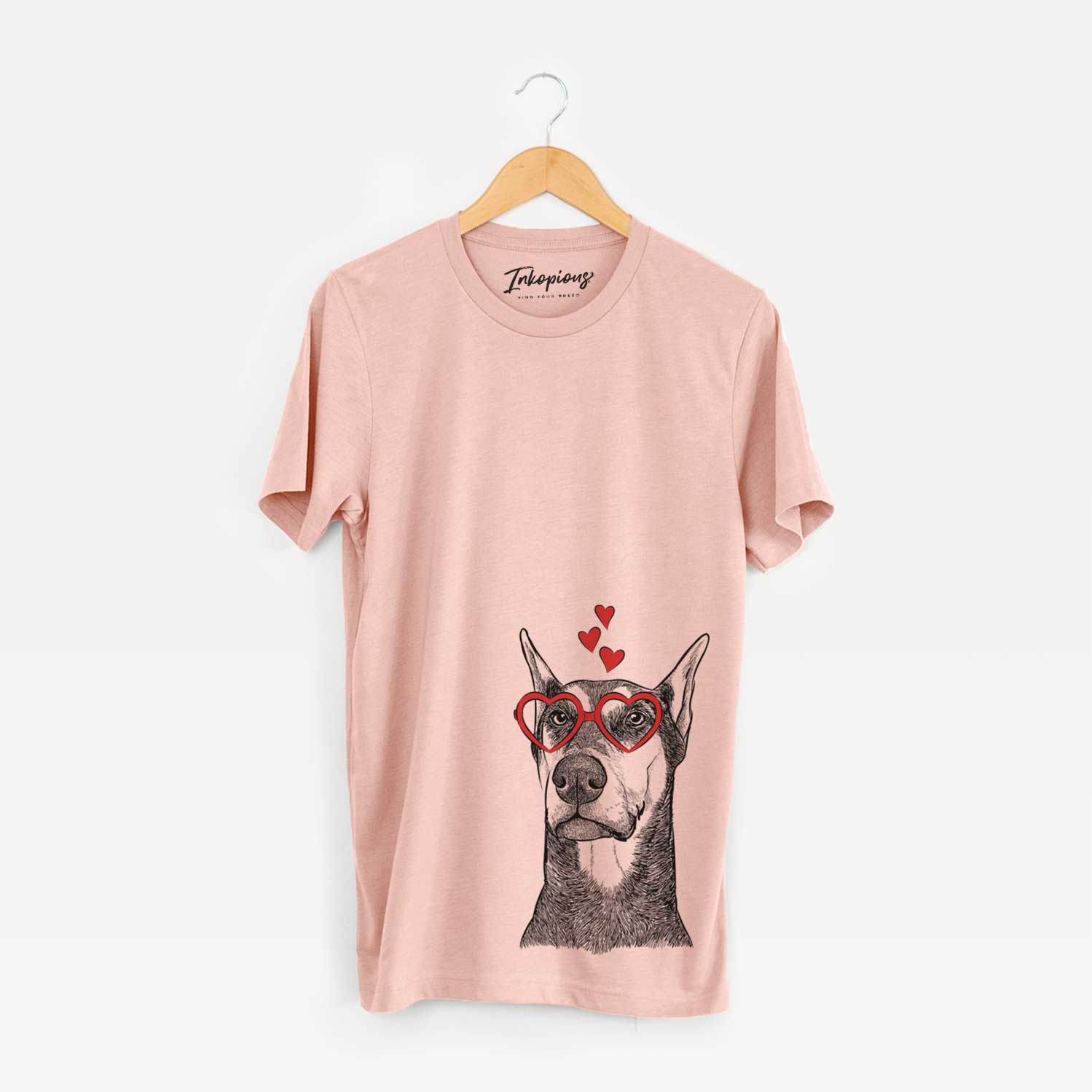 Hand-drawn sketch of Zeus the Doberman Pinscher wearing heart-shaped glasses on a Peach Unisex crewneck