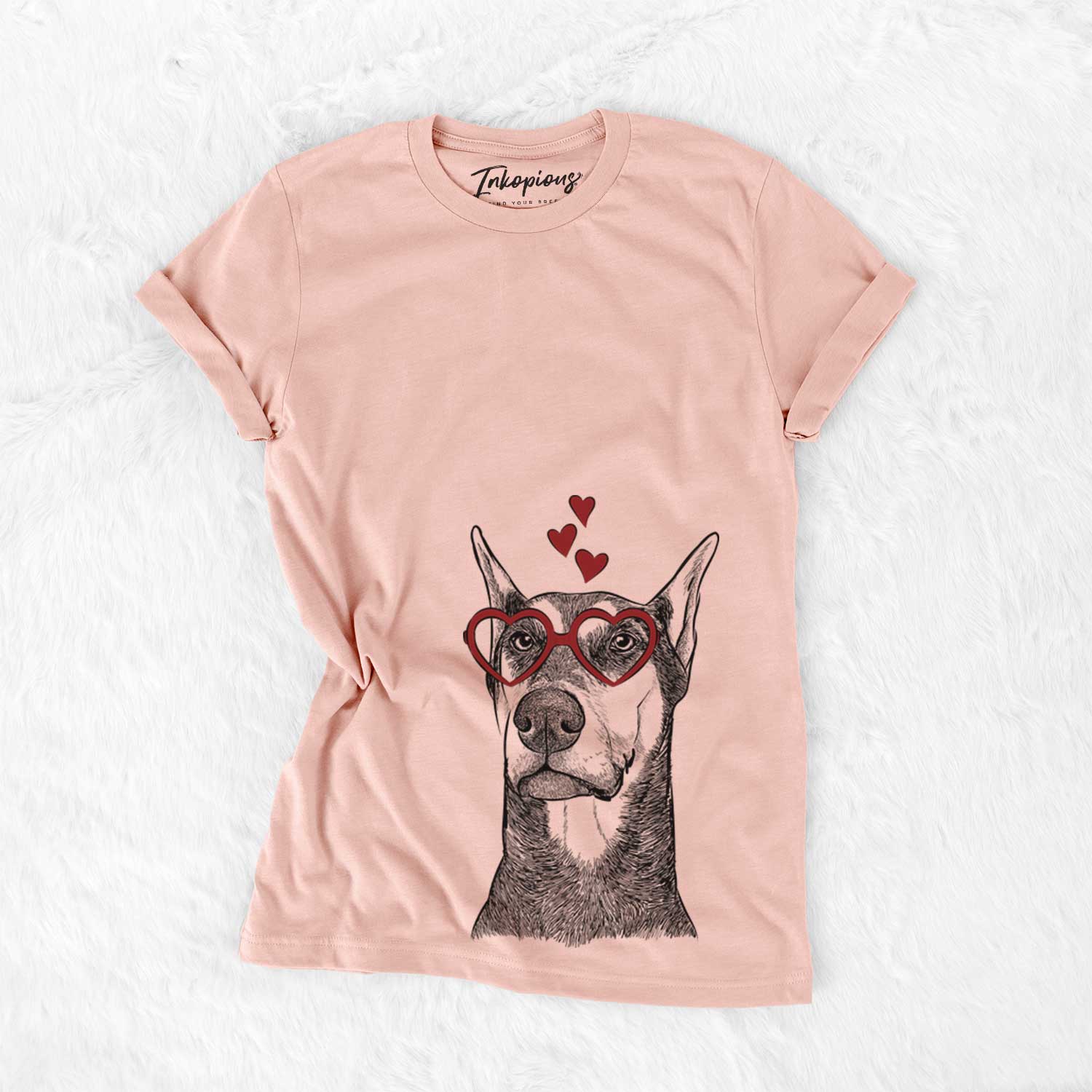 Hand-drawn sketch of Zeus the Doberman Pinscher wearing heart-shaped glasses on a Peach Bella Canvas Unisex Crewneck