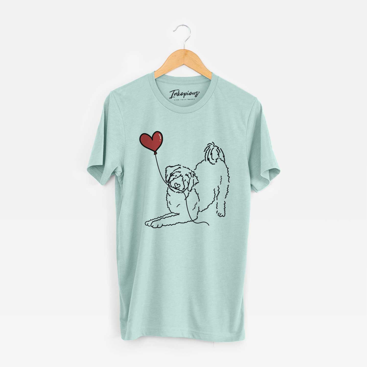 Minimalist line drawing of an Aussiedoodle Heart String holding a heart balloon on a Heather Sage Unisex crewneck