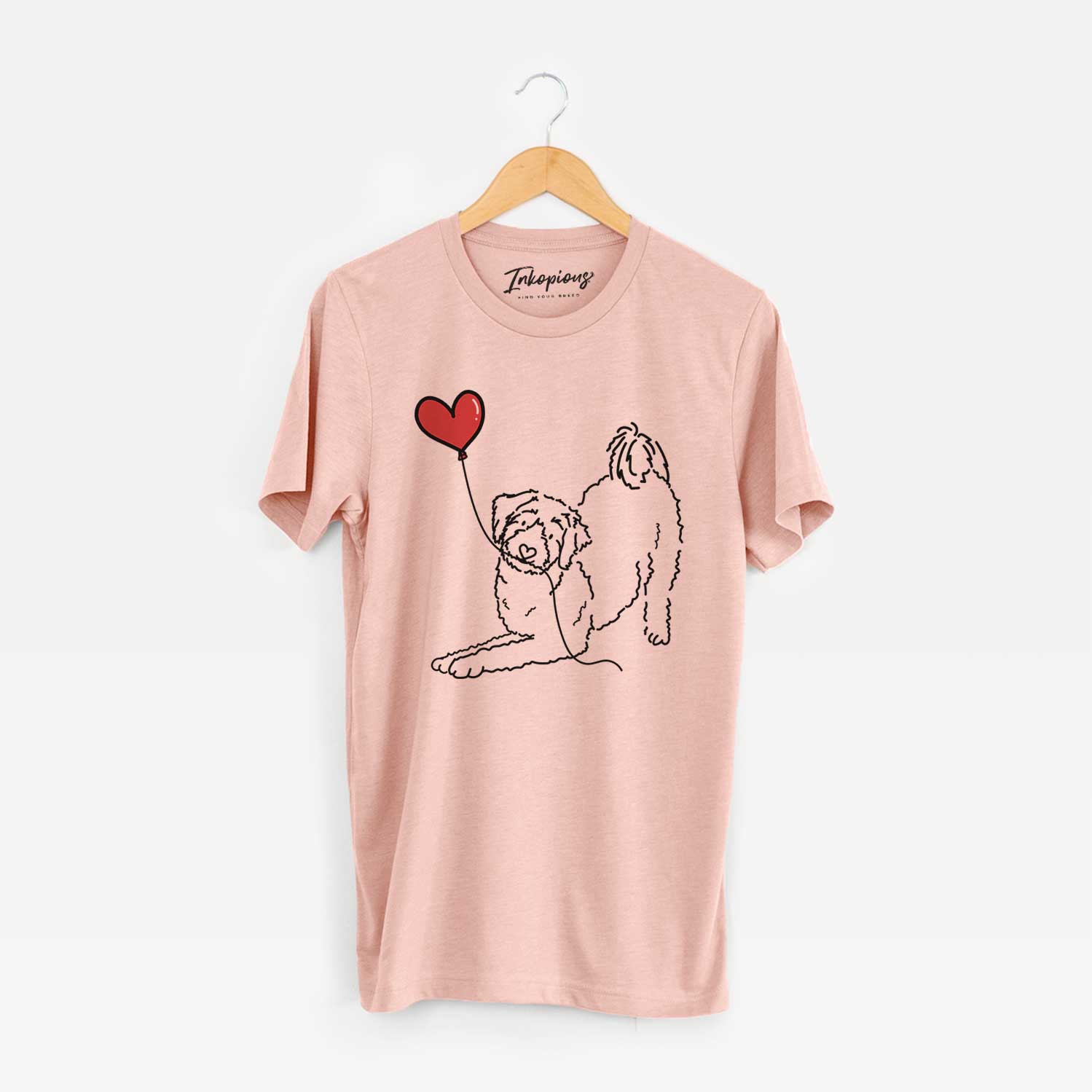 Minimalist line drawing of an Aussiedoodle Heart String holding a heart balloon on a Peach Unisex crewneck