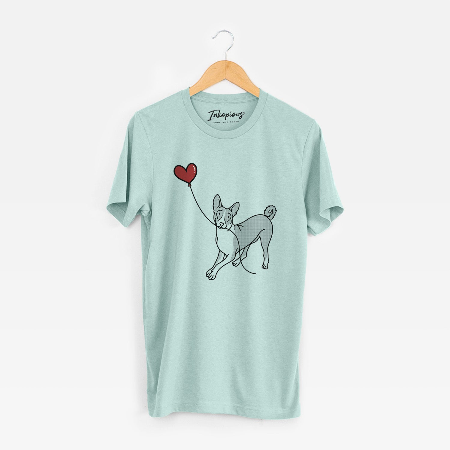 Minimalist line drawing of a Basenji Heart String holding a heart balloon on a Heather Sage Unisex crewneck