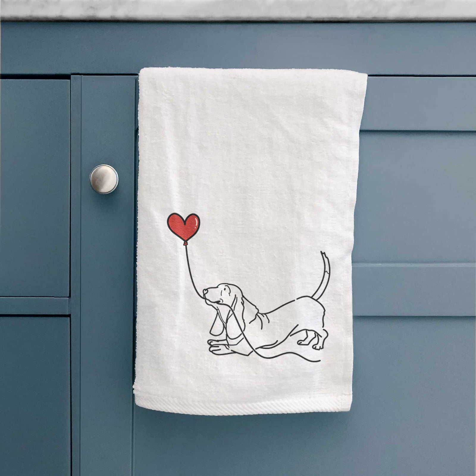 Minimalist line drawing of a Basset Hound Heart String holding a heart balloon on a decorative hand towel