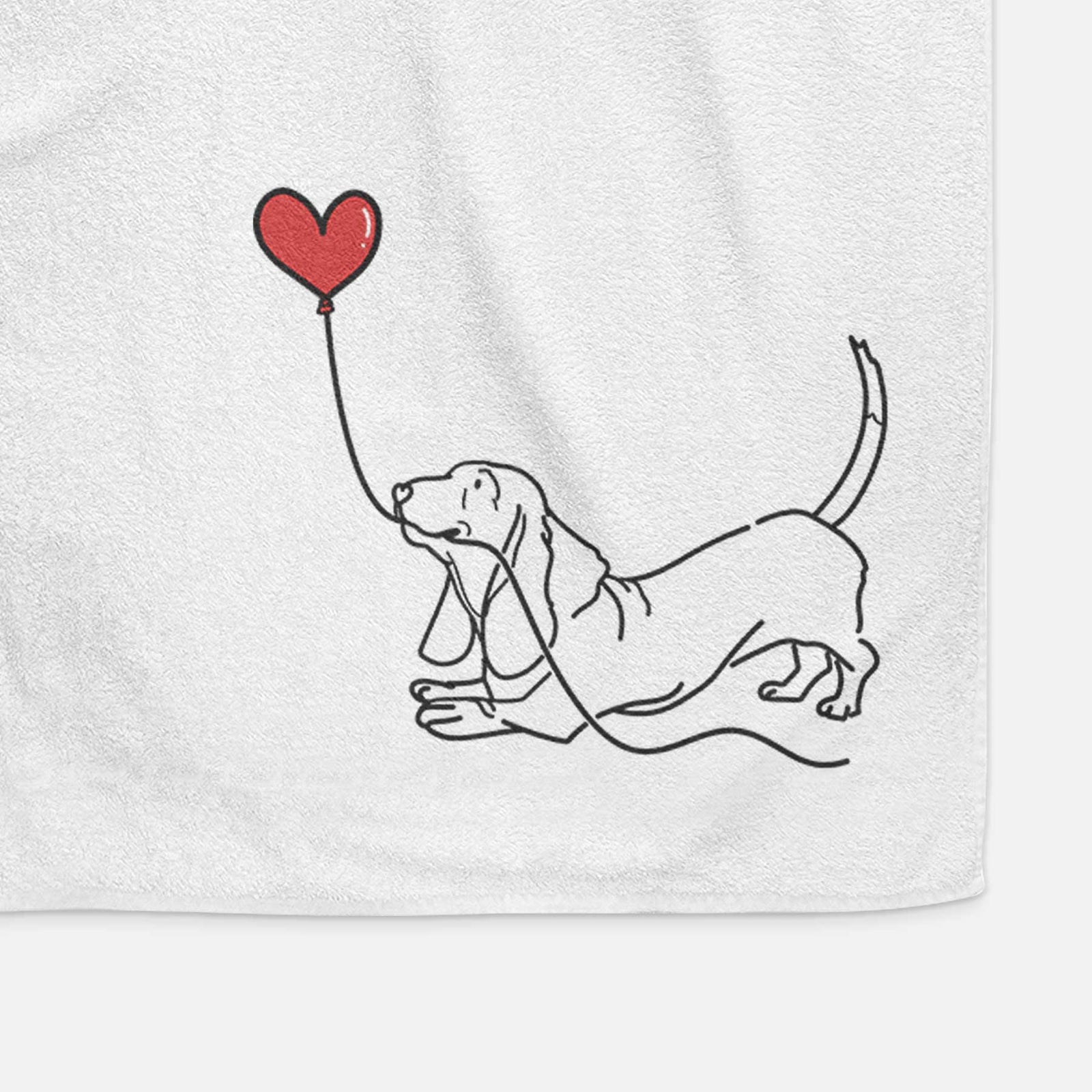 Minimalist line drawing of a Basset Hound Heart String holding a heart balloon on a decorative hand towel