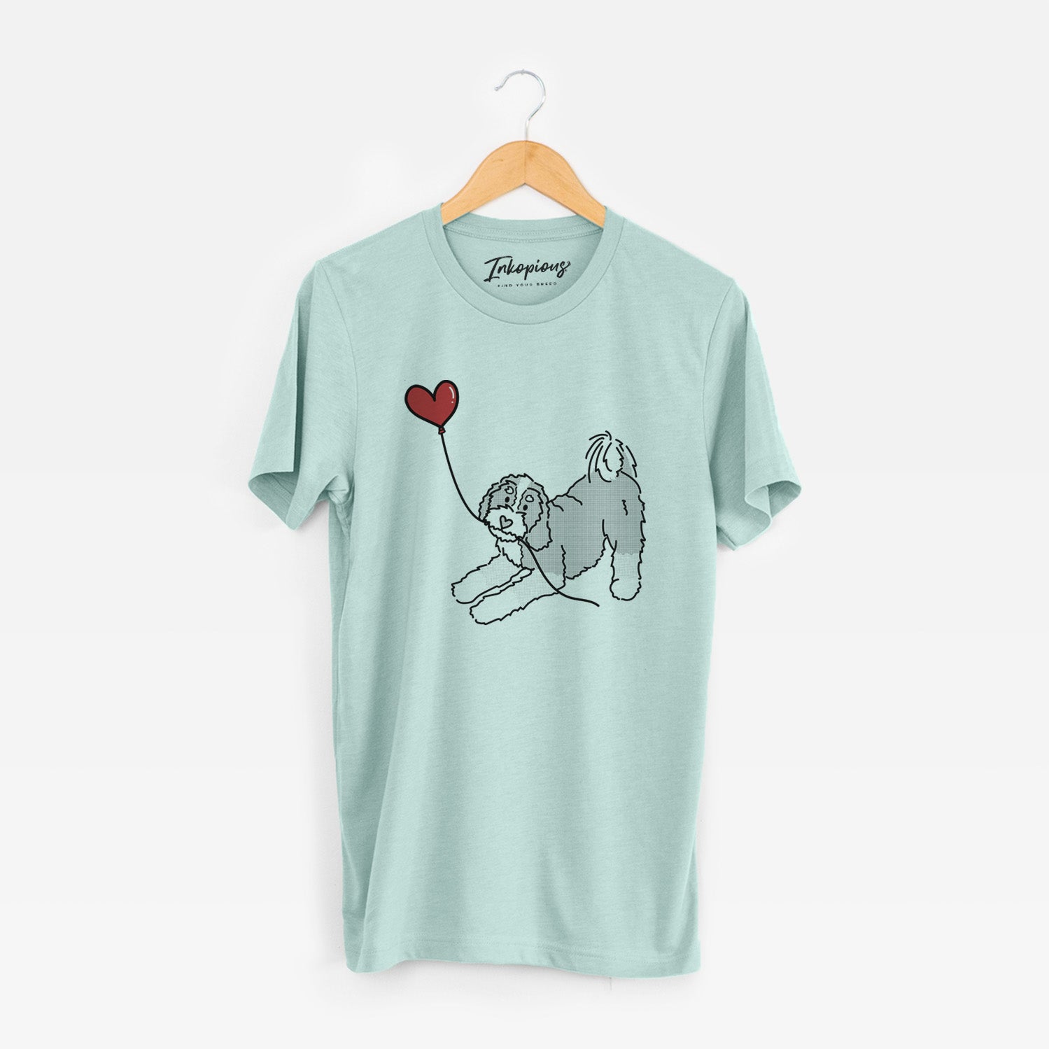 Minimalist line drawing of a Bernedoodle Heart String holding a heart balloon on a Heather Sage Unisex crewneck
