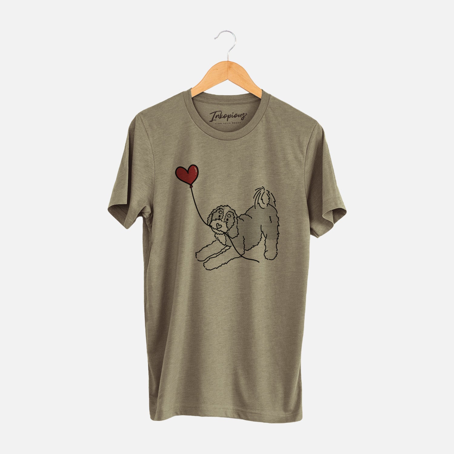 Minimalist line drawing of a Bernedoodle Heart String holding a heart balloon on an Olive Unisex crewneck