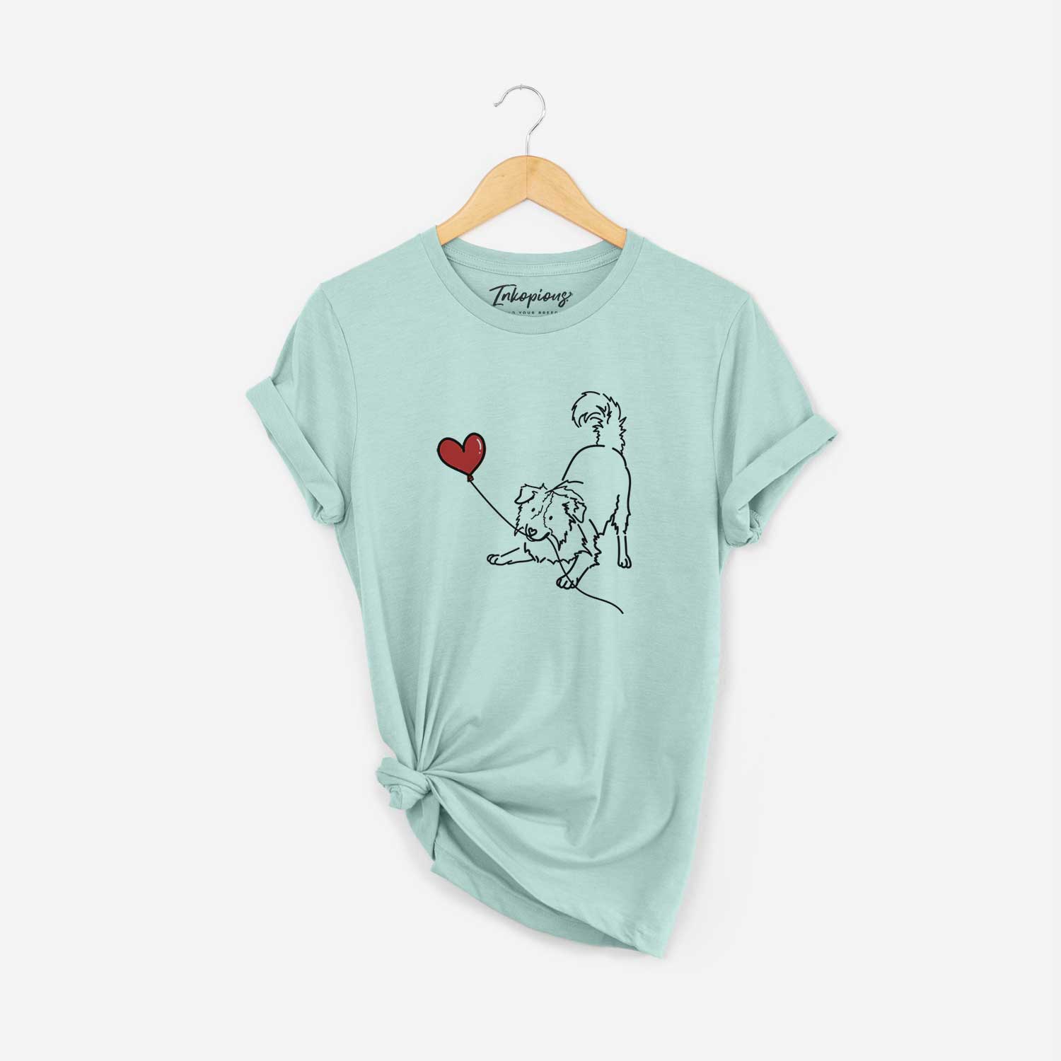 Minimalist line drawing of a Border Collie Heart String holding a heart balloon on a Heather Sage Unisex crewneck