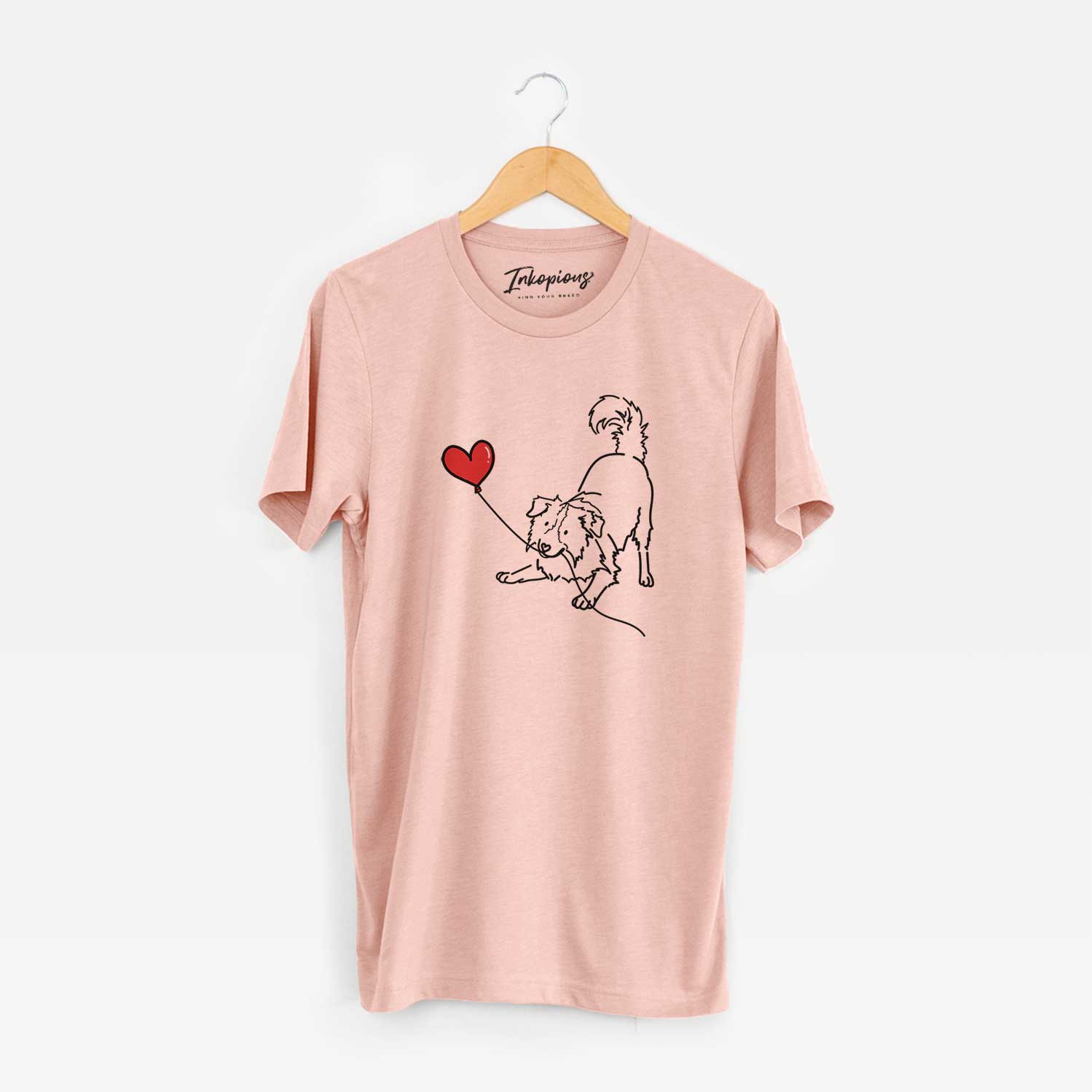 Minimalist line drawing of a Border Collie Heart String holding a heart balloon on a Peach Unisex crewneck