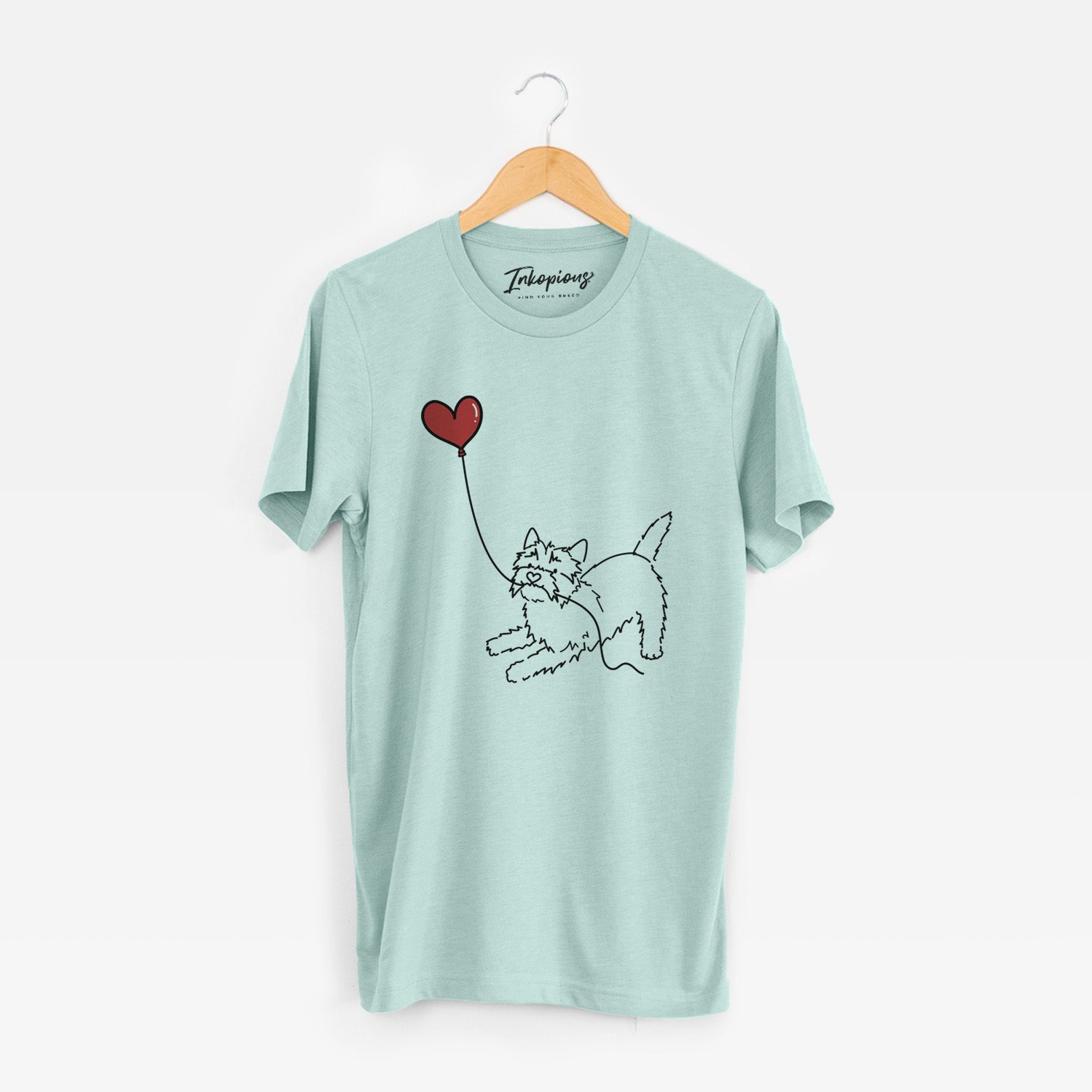 Minimalist line drawing of a Cairn Terrier Heart String holding a heart balloon on a Heather Sage Unisex crewneck