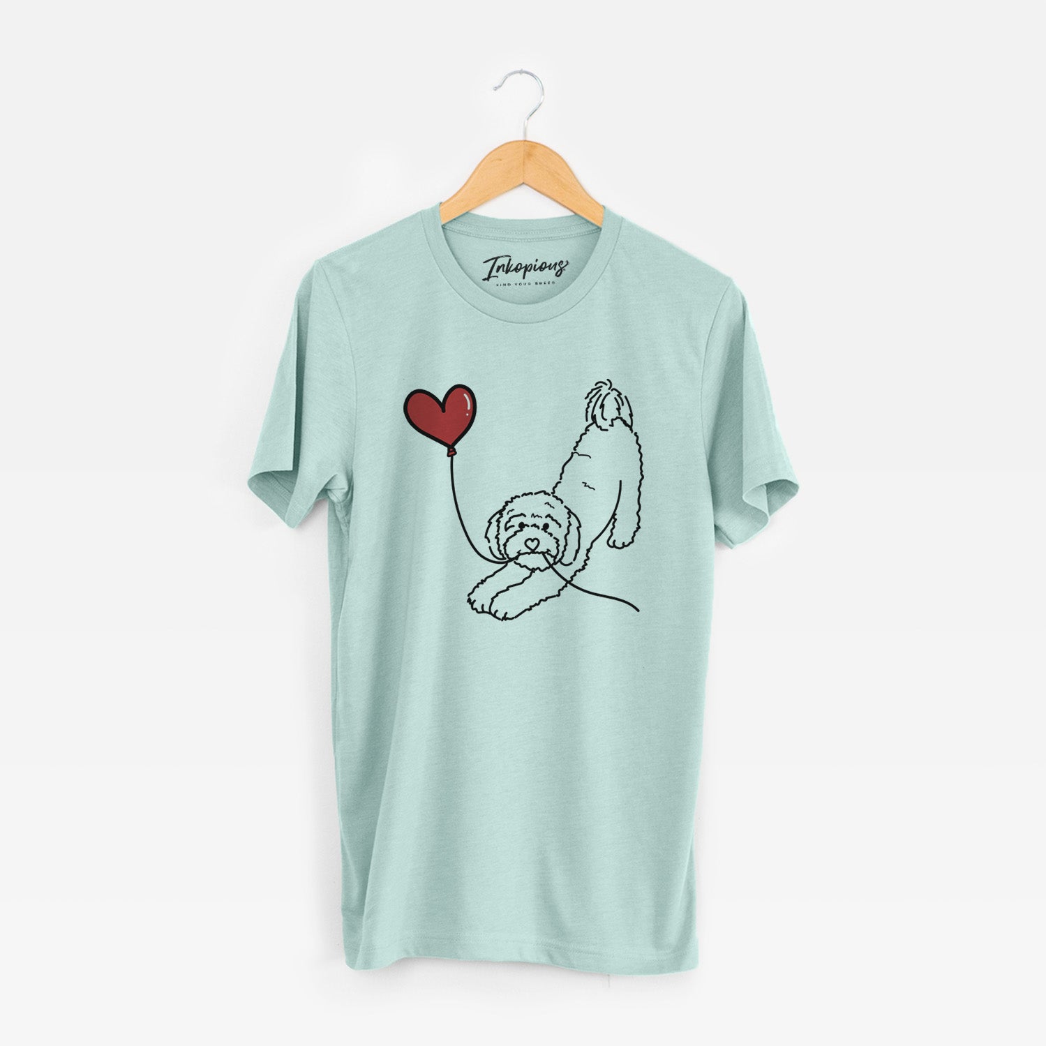 Minimalist line drawing of a Cavapoo Heart String holding a heart balloon on a Heather Sage Unisex crewneck