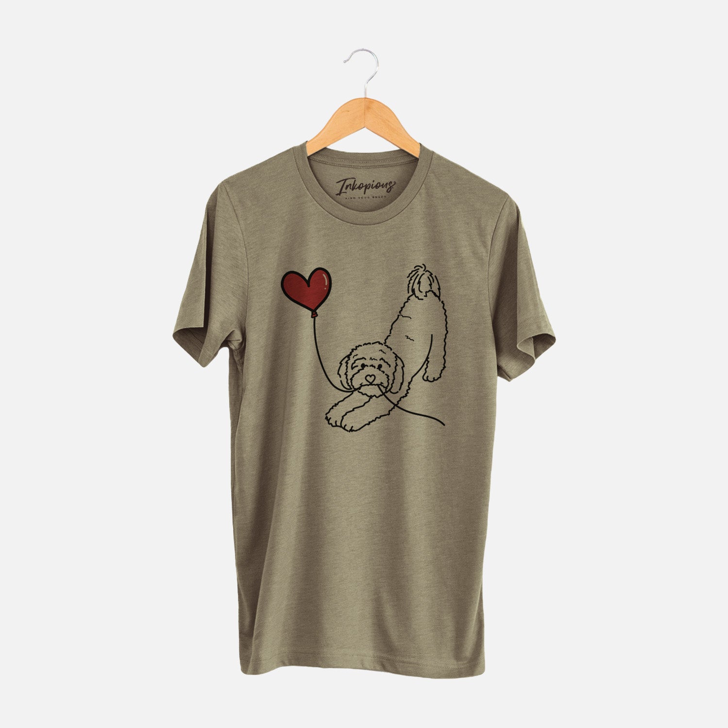 Minimalist line drawing of a Cavapoo Heart String holding a heart balloon on an Olive Unisex crewneck