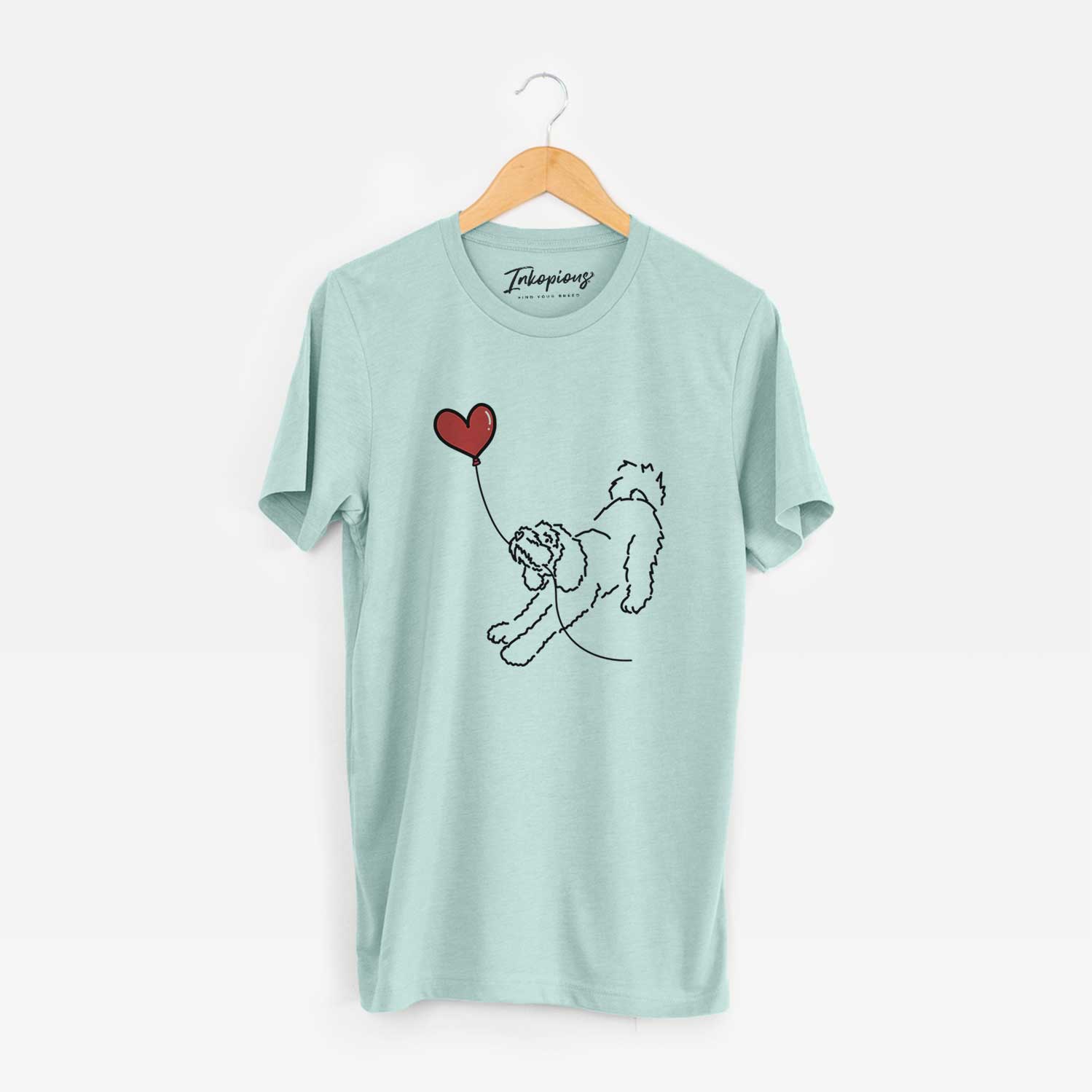 Minimalist line drawing of a Cockapoo Heart String holding a heart balloon on a Heather Sage Unisex crewneck