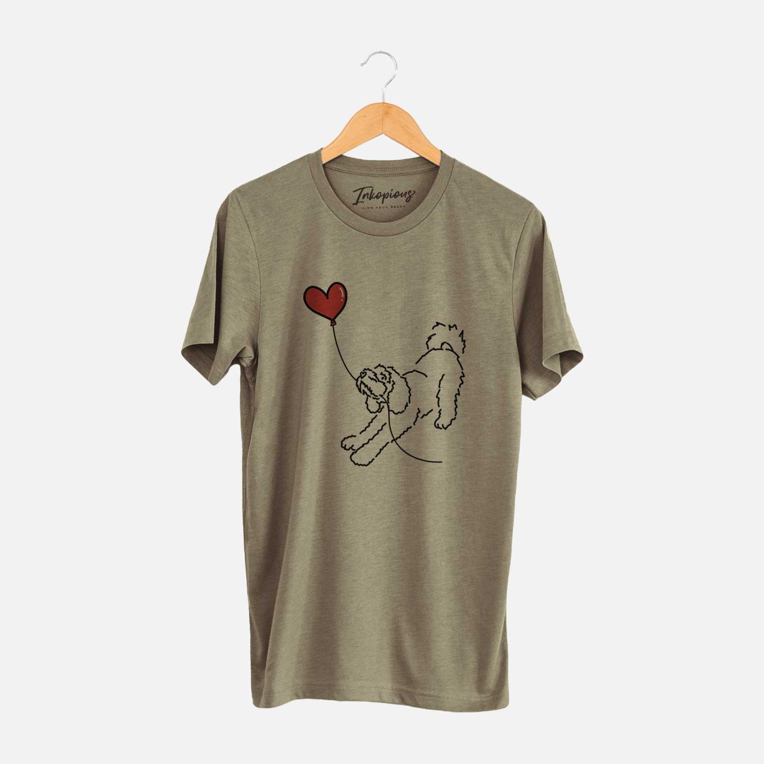 Minimalist line drawing of a Cockapoo Heart String holding a heart balloon on an Olive Unisex crewneck