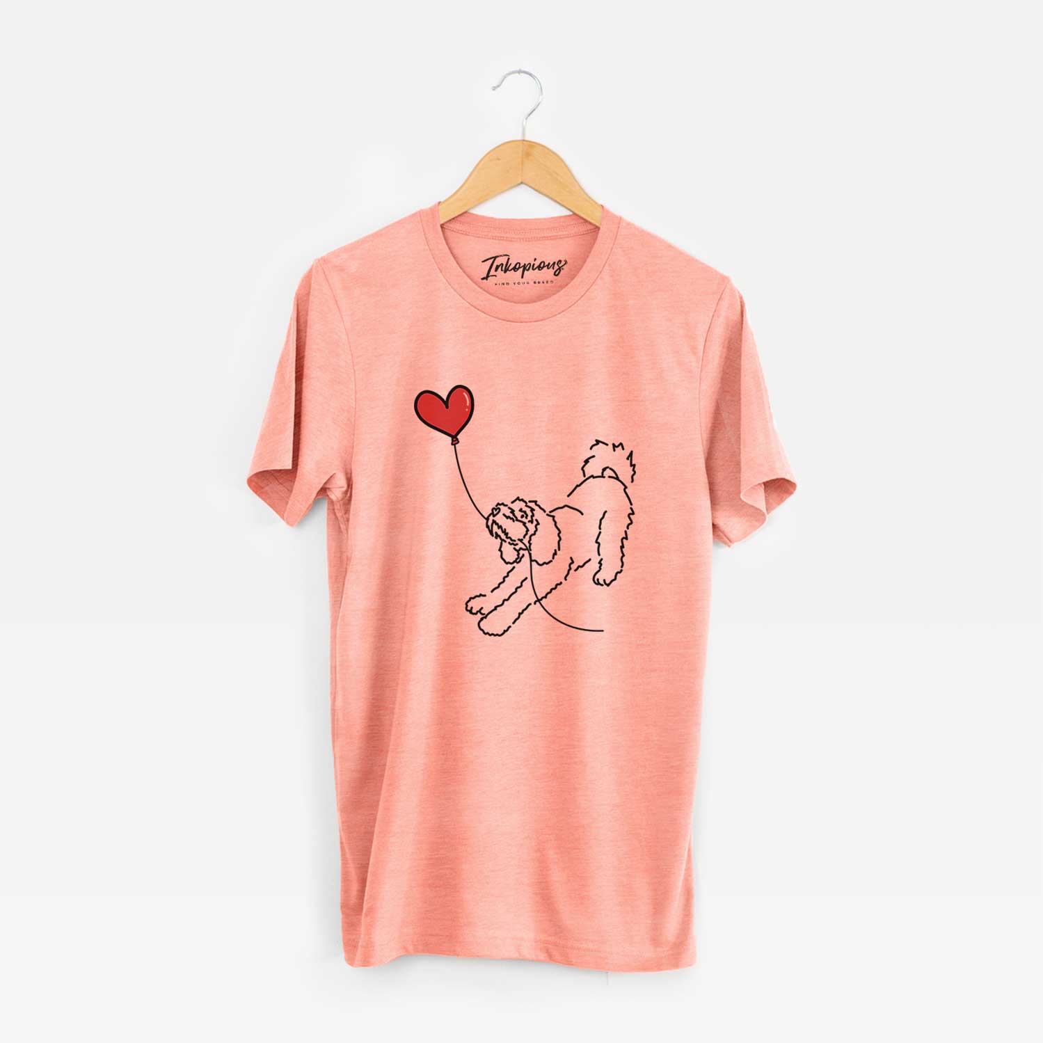 Minimalist line drawing of a Cockapoo Heart String holding a heart balloon on a Sunset Unisex crewneck