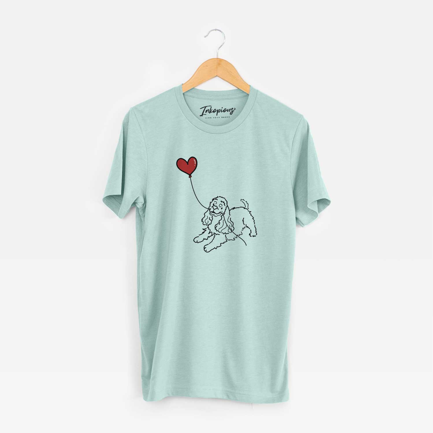 Minimalist line drawing of a Cocker Spaniel Heart String holding a heart balloon on a Heather Sage Unisex crewneck