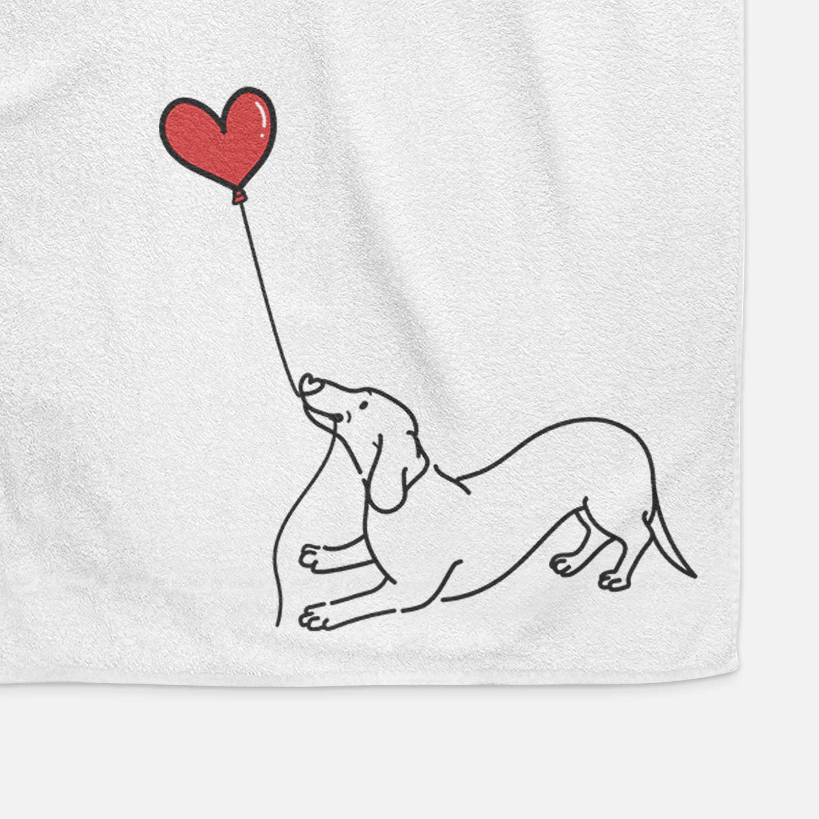 Minimalist line drawing of a Dachshund Heart String holding a heart balloon on a decorative hand towel