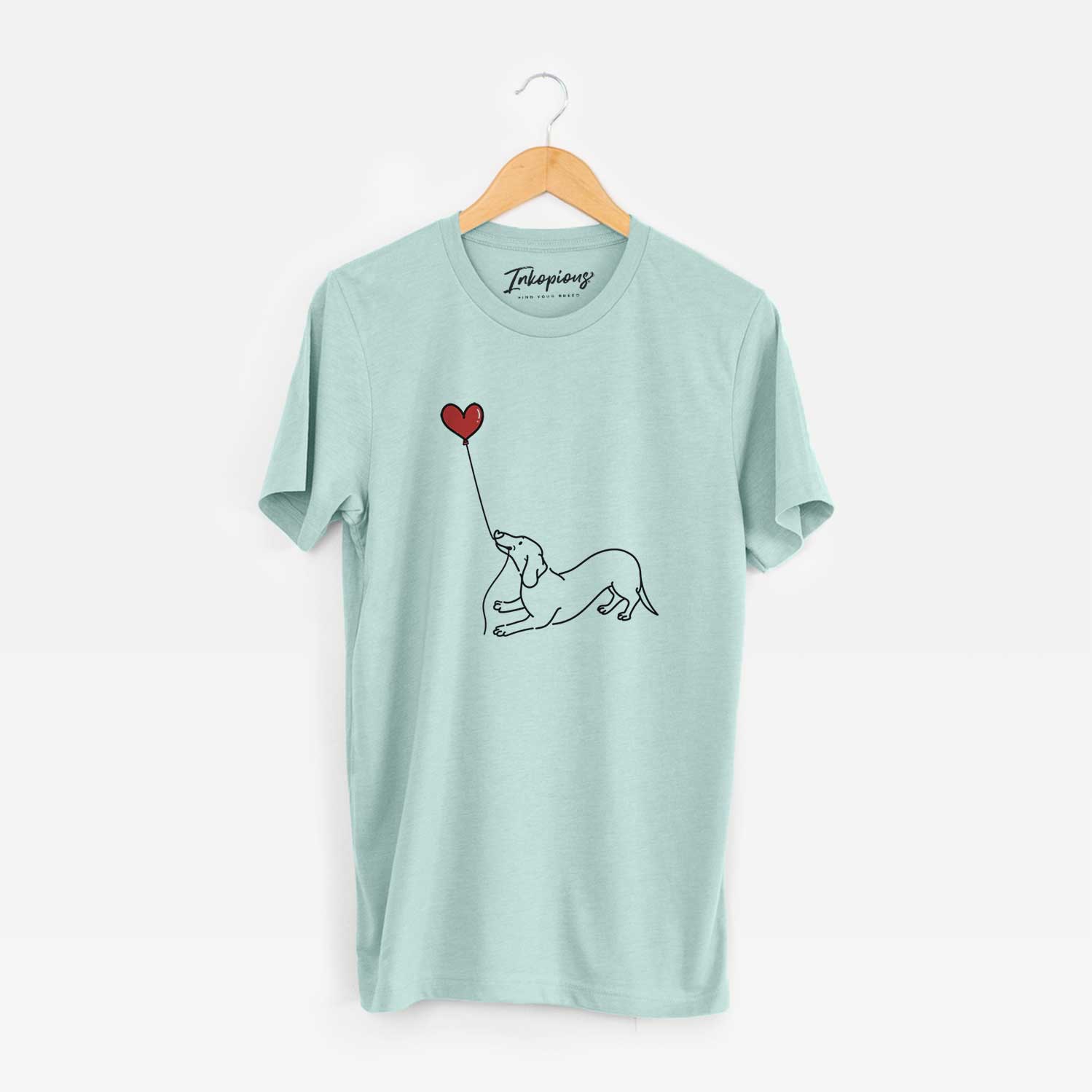 Minimalist line drawing of a Dachshund Heart String holding a heart balloon on a Heather Sage Unisex crewneck