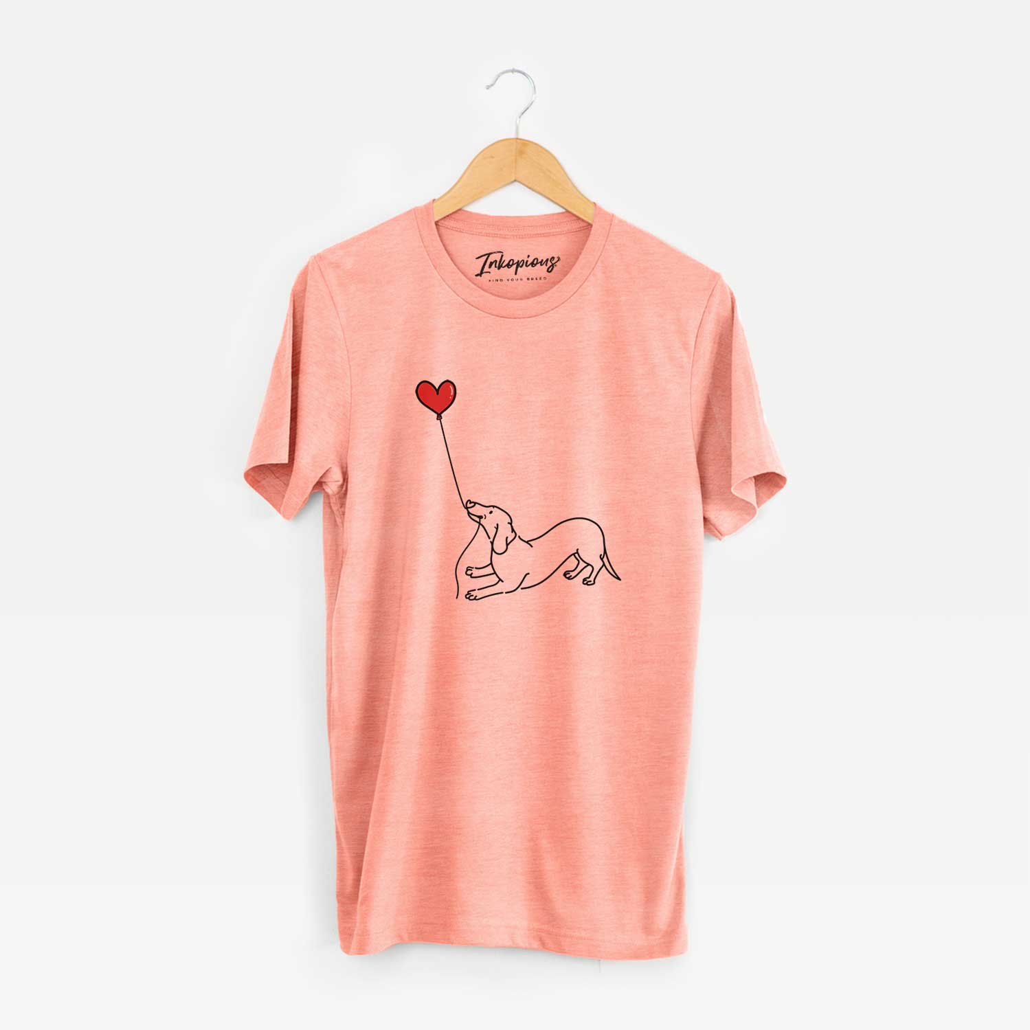 Minimalist line drawing of a Dachshund Heart String holding a heart balloon on a Sunset Unisex crewneck