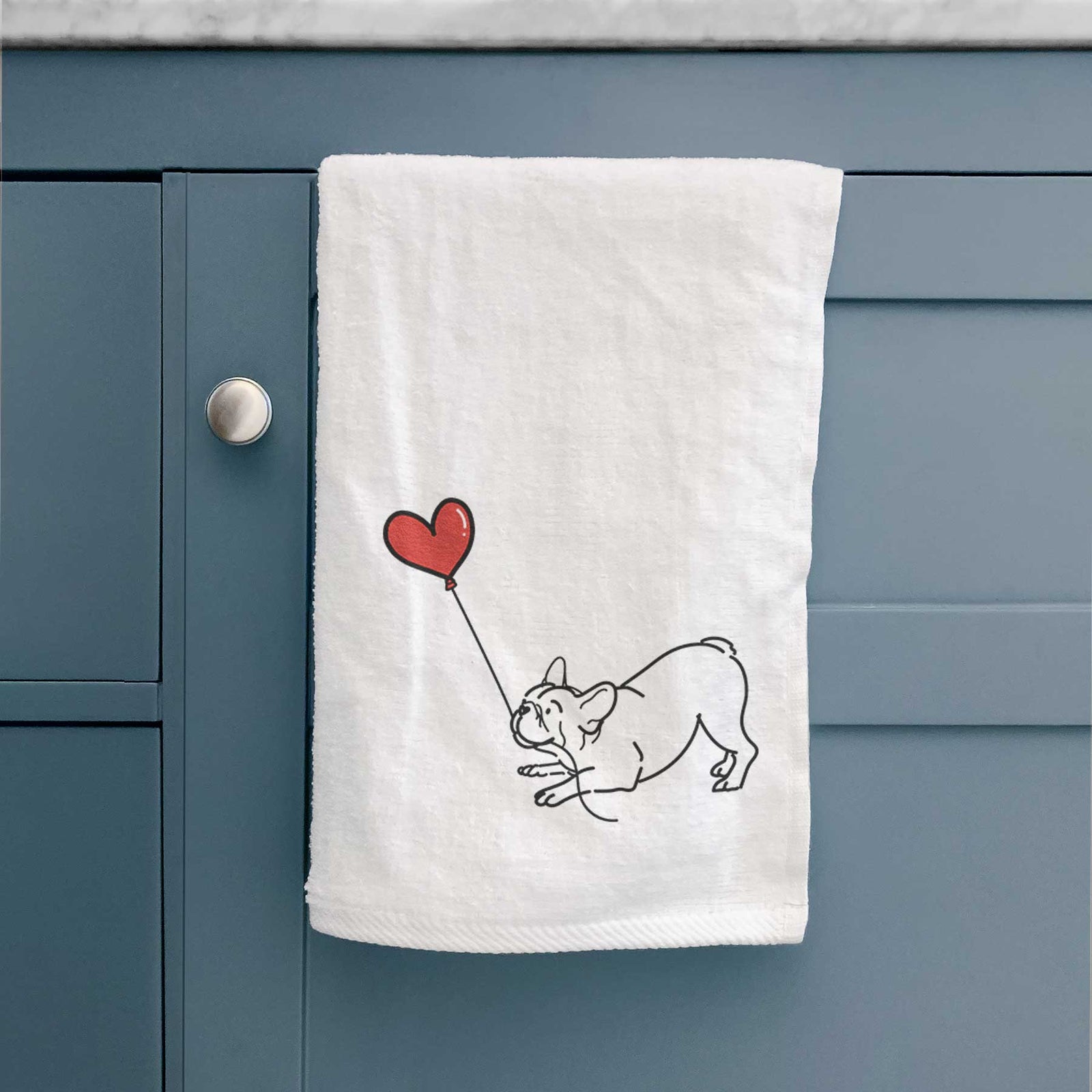 Minimalist line drawing of a Frenchie Heart String holding a heart balloon on a decorative hand towel