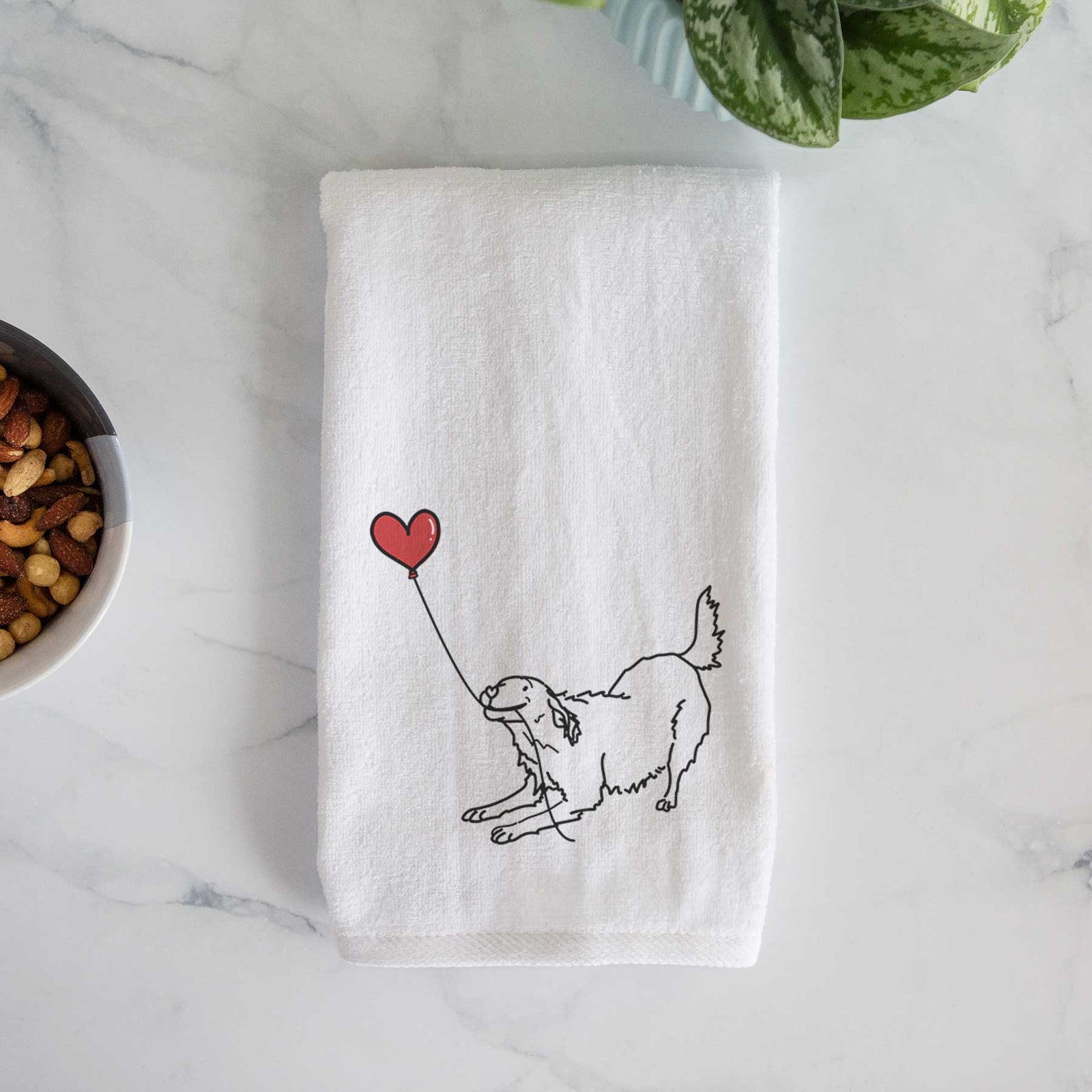 Minimalist line drawing of a Golden Retriever Heart String holding a heart balloon on a decorative hand towel