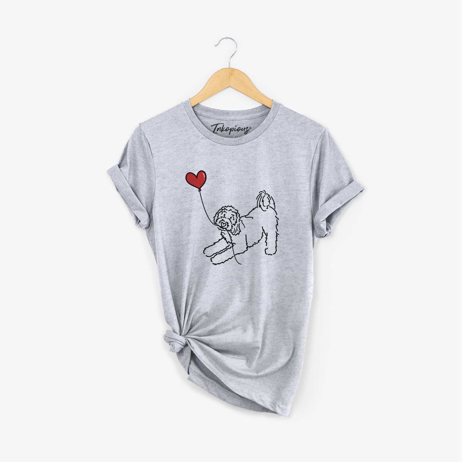 Minimalist line drawing of a Goldendoodle Heart String holding a heart balloon on a Grey Unisex crewneck