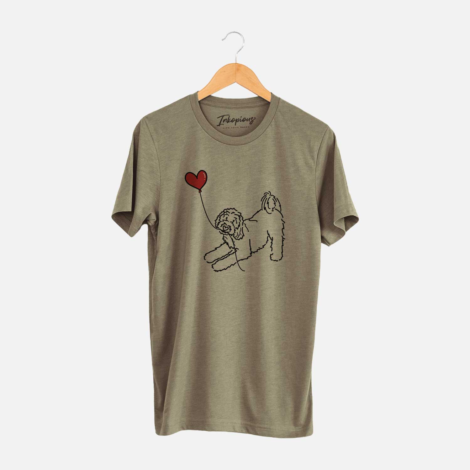 Minimalist line drawing of a Goldendoodle Heart String holding a heart balloon on an Olive Unisex crewneck