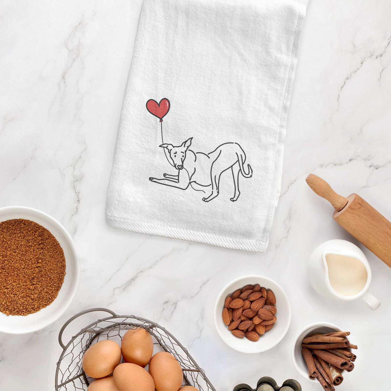 Minimalist line drawing of a Greyhound Heart String holding a heart balloon on a decorative hand towel