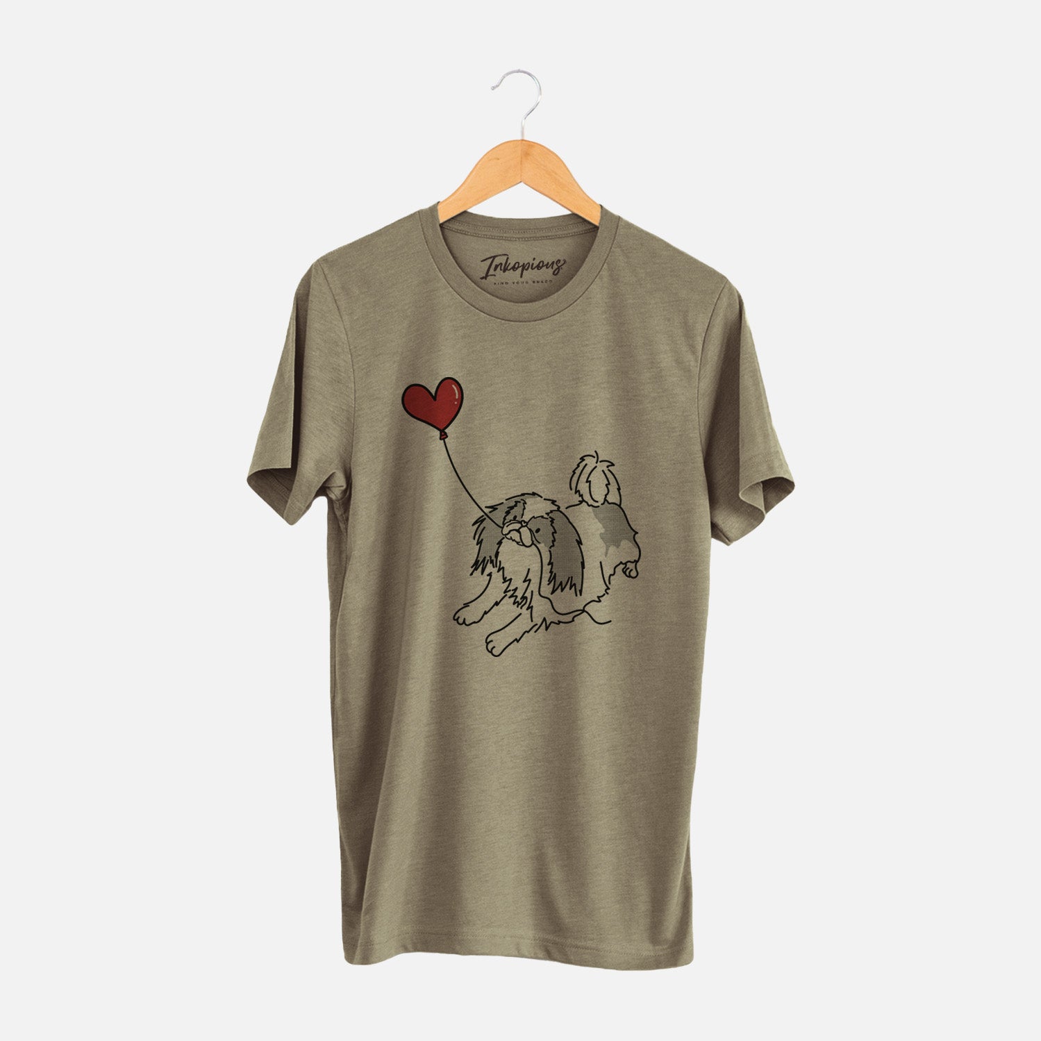 Minimalist line drawing of a Japanese Chin Heart String holding a heart balloon on an Olive Unisex crewneck