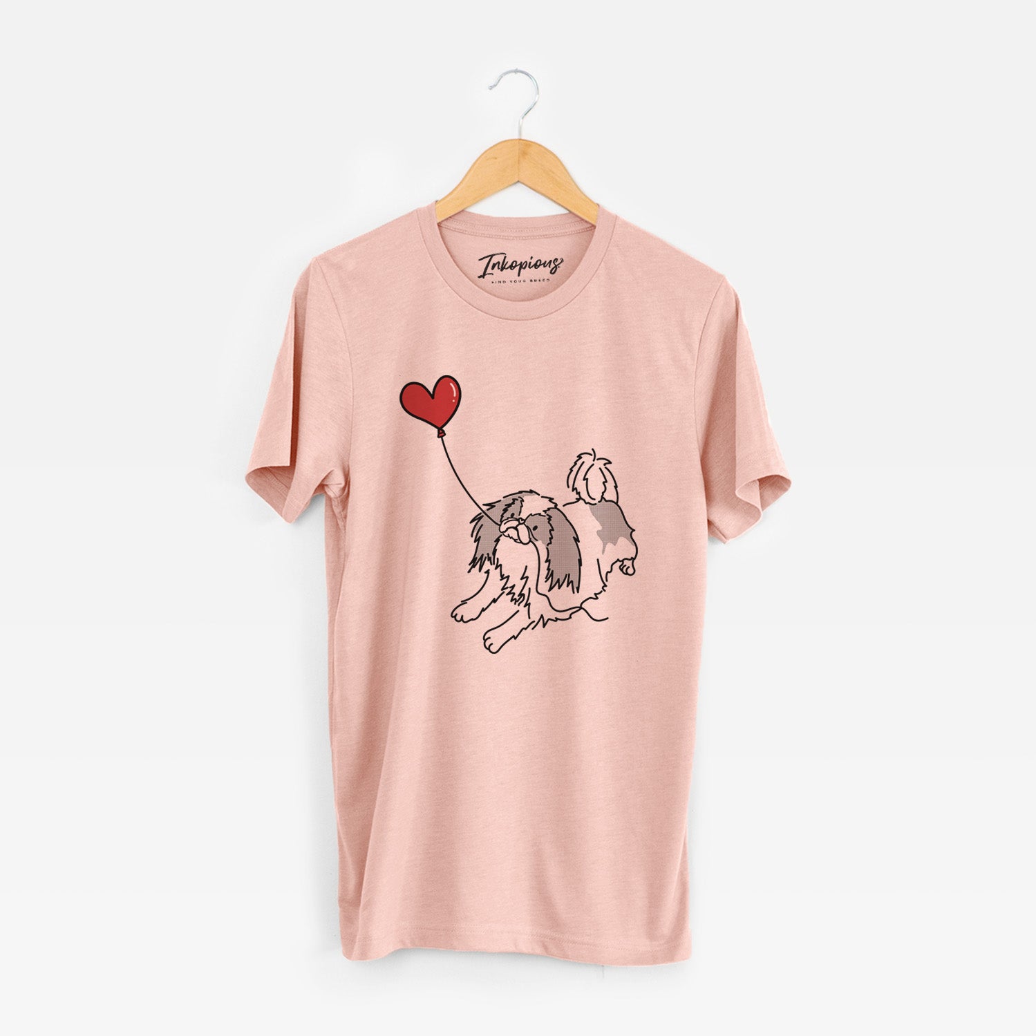 Minimalist line drawing of a Japanese Chin Heart String holding a heart balloon on a Peach Unisex crewneck