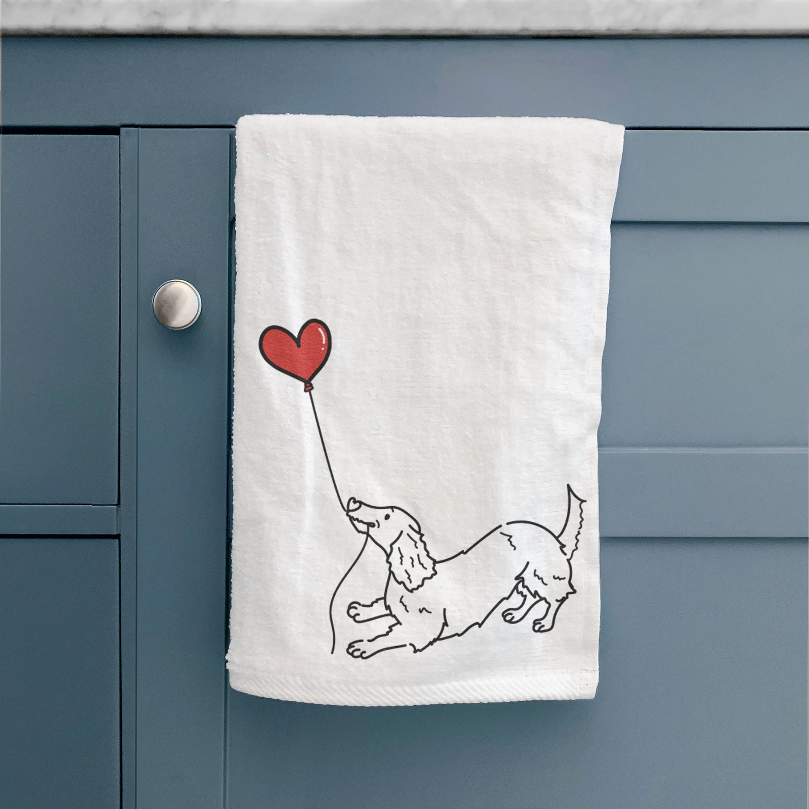 Minimalist line drawing of a Long Haired Dachshund Heart String holding a heart balloon on a decorative hand towel