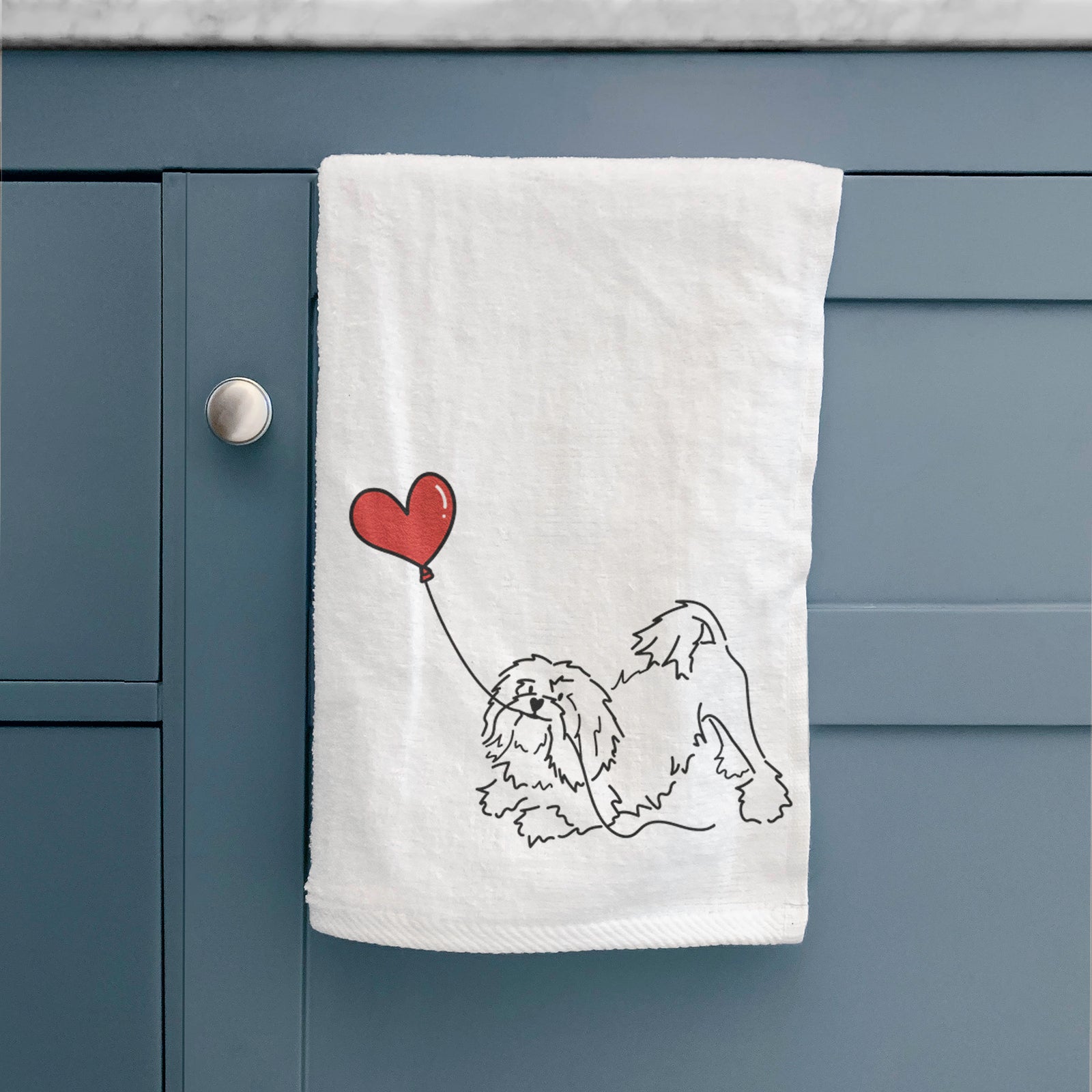 Minimalist line drawing of a Lowchen Heart String holding a heart balloon on a decorative hand towel