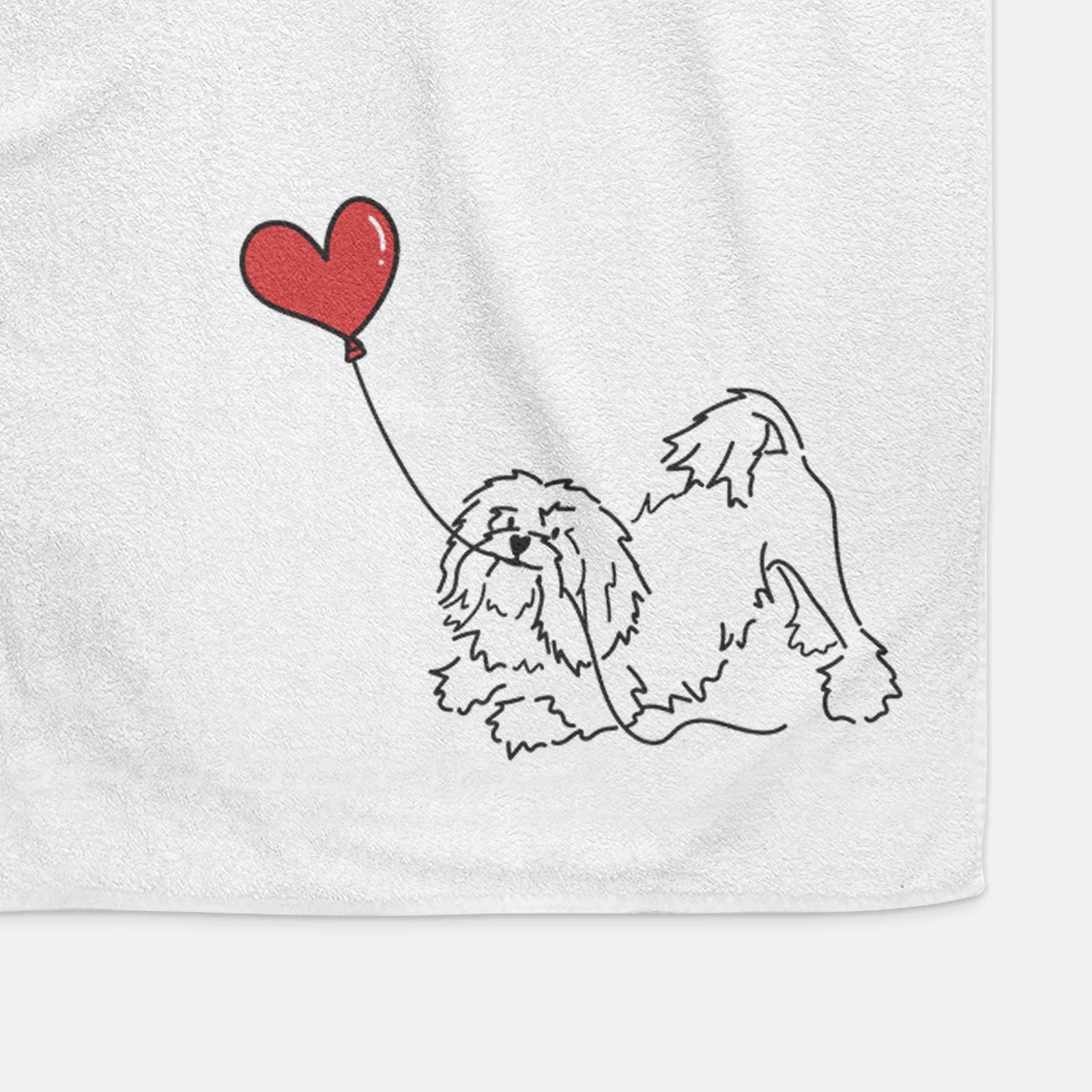 Minimalist line drawing of a Lowchen Heart String holding a heart balloon on a decorative hand towel