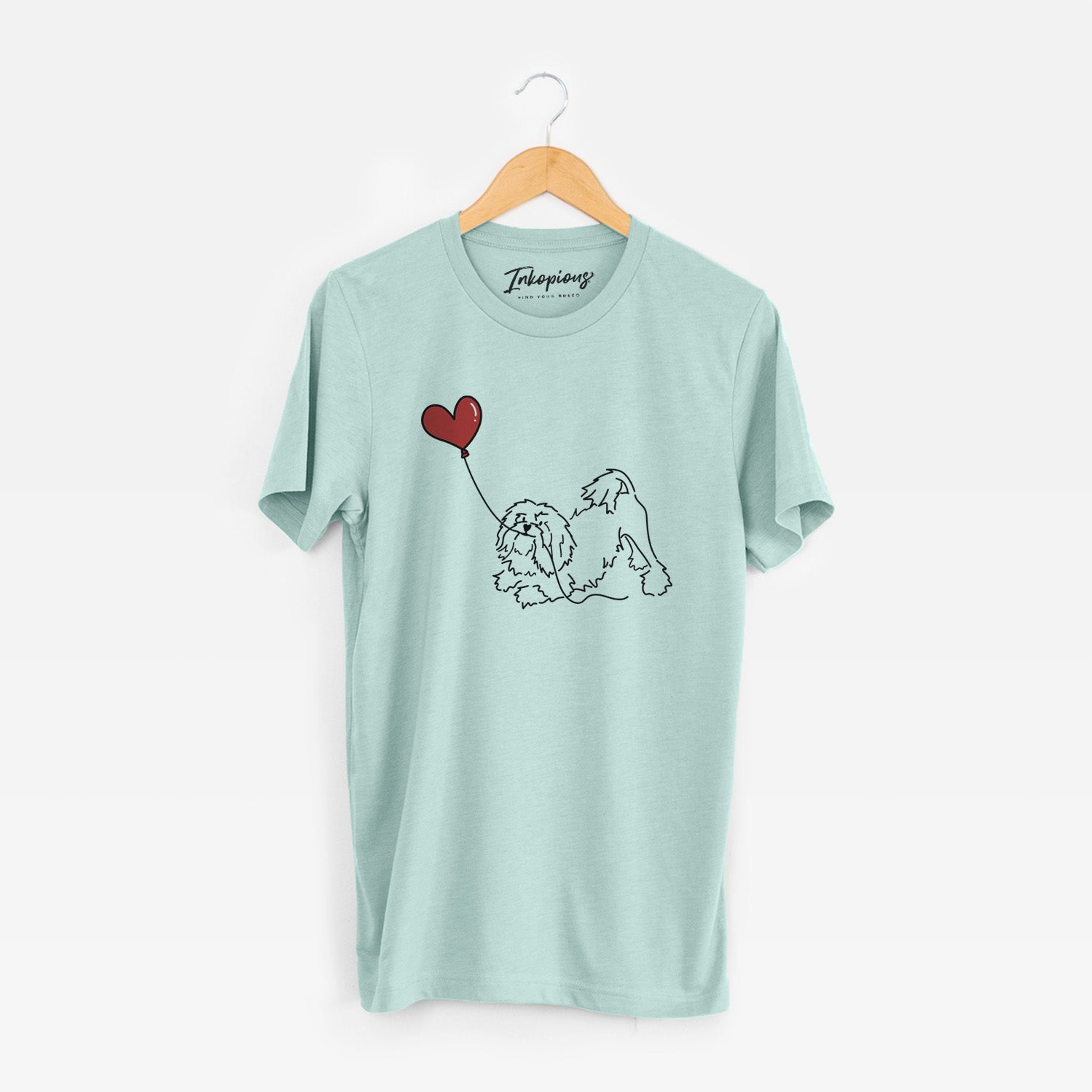Minimalist line drawing of a Lowchen Heart String holding a heart balloon on a Heather Sage Unisex crewneck