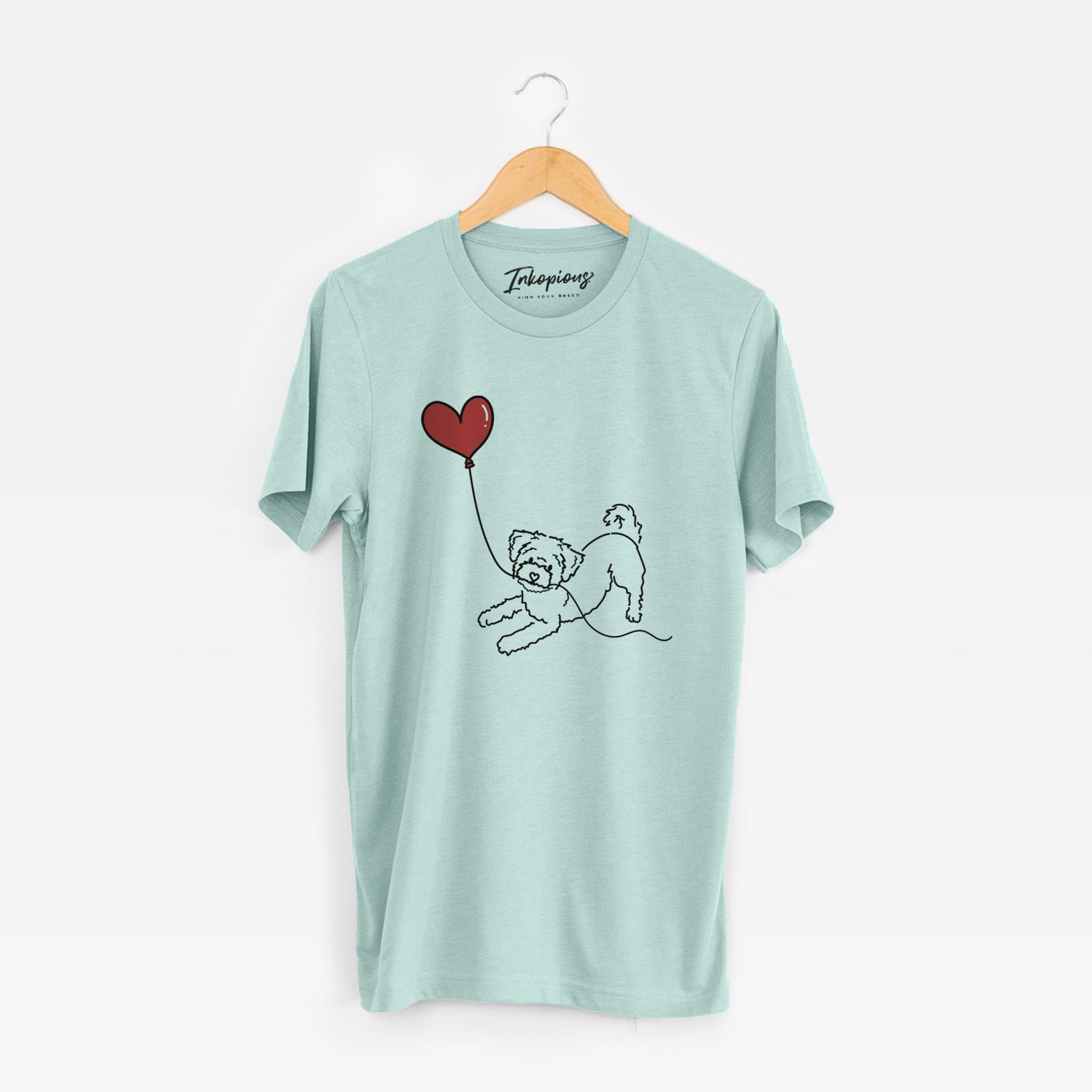Minimalist line drawing of a Morkie Heart String holding a heart balloon on a Heather Sage Unisex crewneck