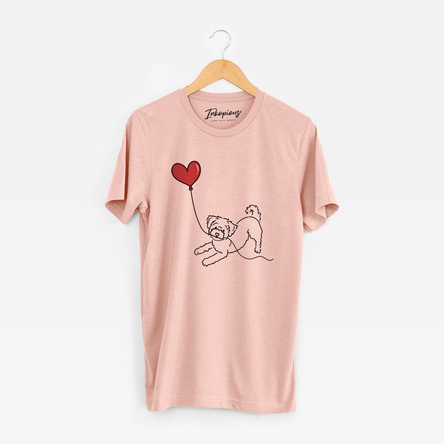 Minimalist line drawing of a Morkie Heart String holding a heart balloon on a Peach Unisex crewneck