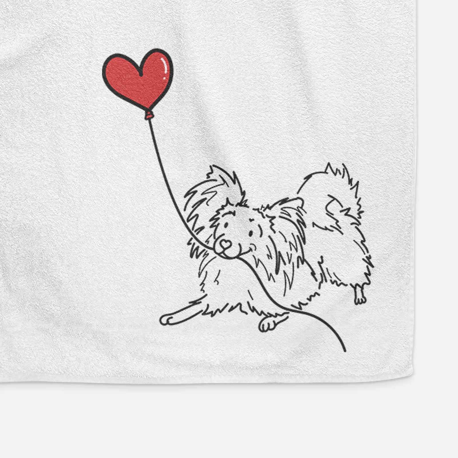 Minimalist line drawing of a Papillon Heart String holding a heart balloon on a decorative hand towel