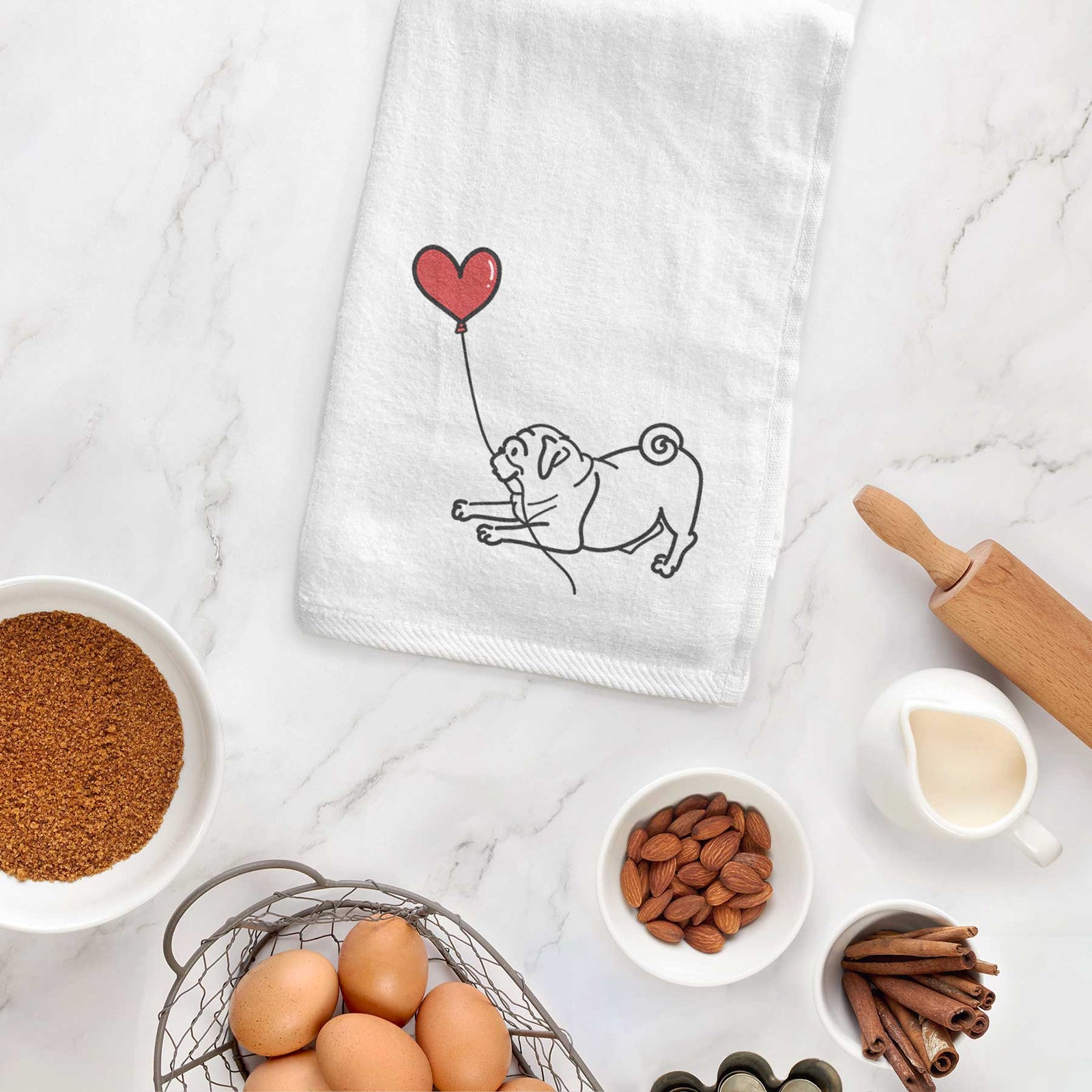 Minimalist line drawing of a Pug Heart String holding a heart balloon on a decorative hand towel