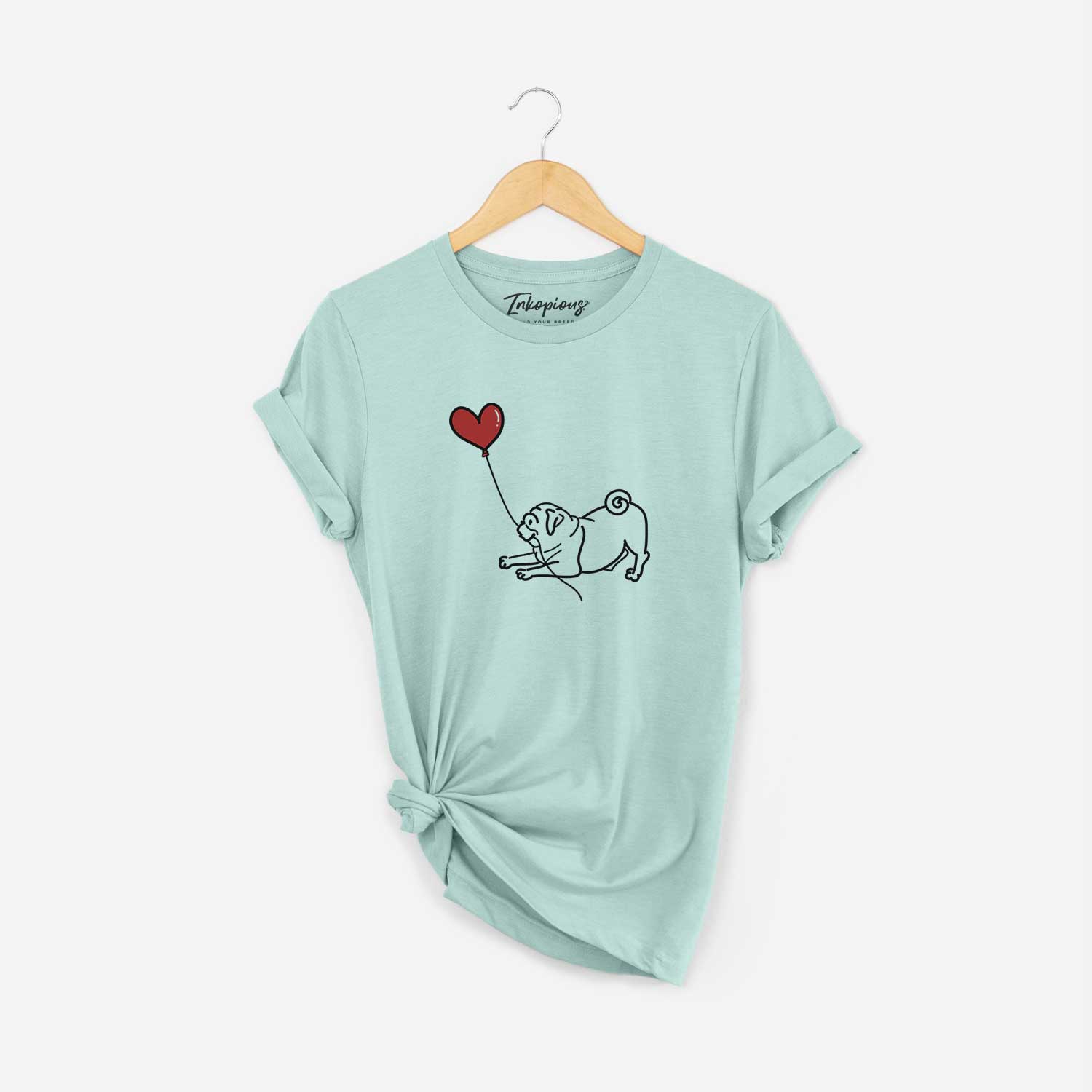 Minimalist line drawing of a Pug Heart String holding a heart balloon on a Heather Sage Unisex crewneck