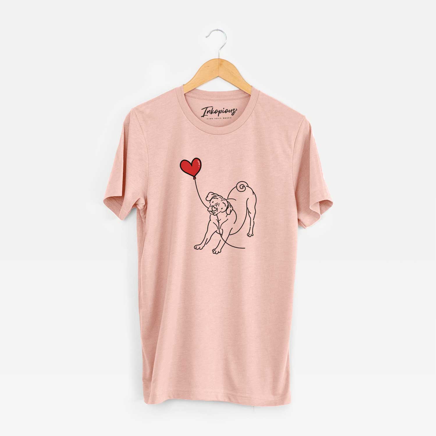 Minimalist line drawing of a Puggle Heart String holding a heart balloon on a Peach Unisex crewneck