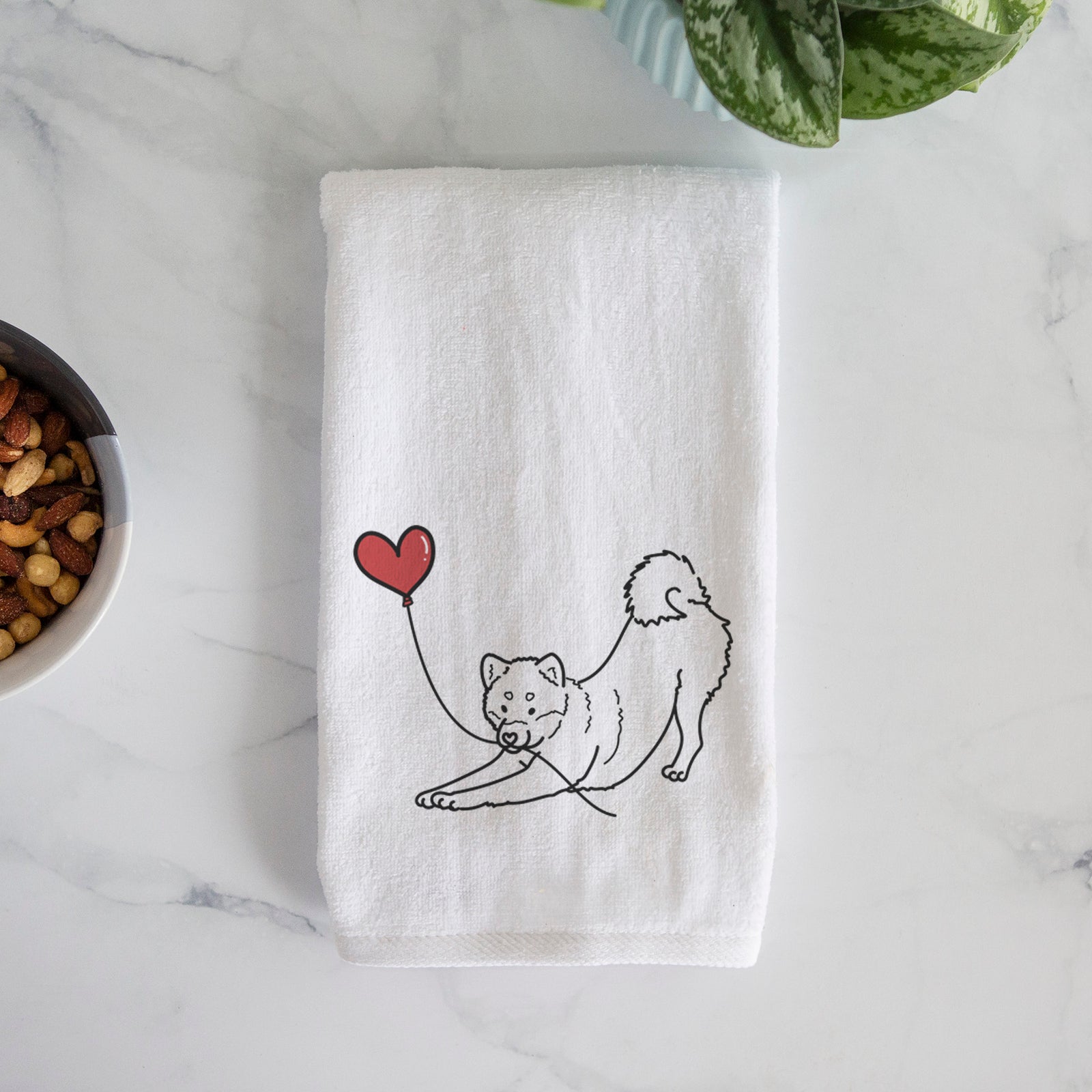 Minimalist line drawing of a Shiba Inu Heart String holding a heart balloon on a decorative hand towel