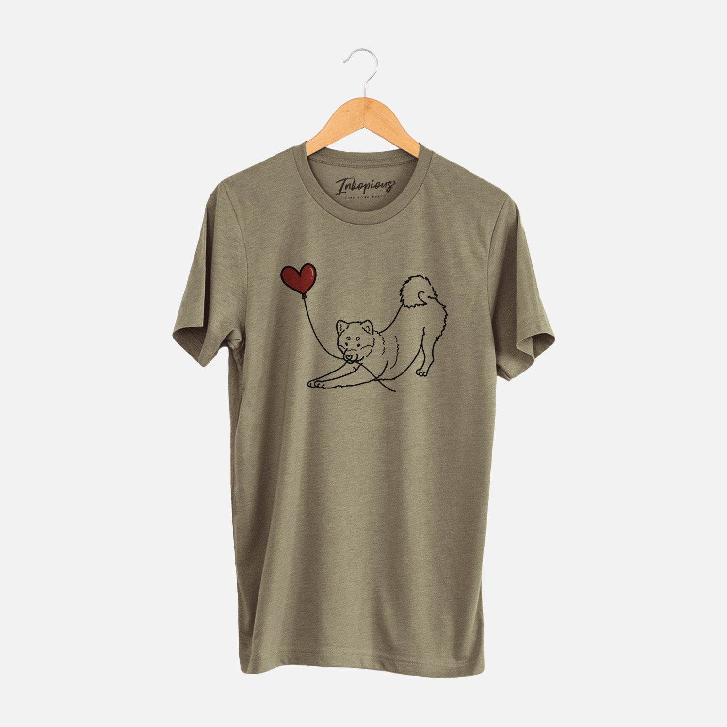Minimalist line drawing of a Shiba Inu Heart String holding a heart balloon on an Olive Unisex crewneck