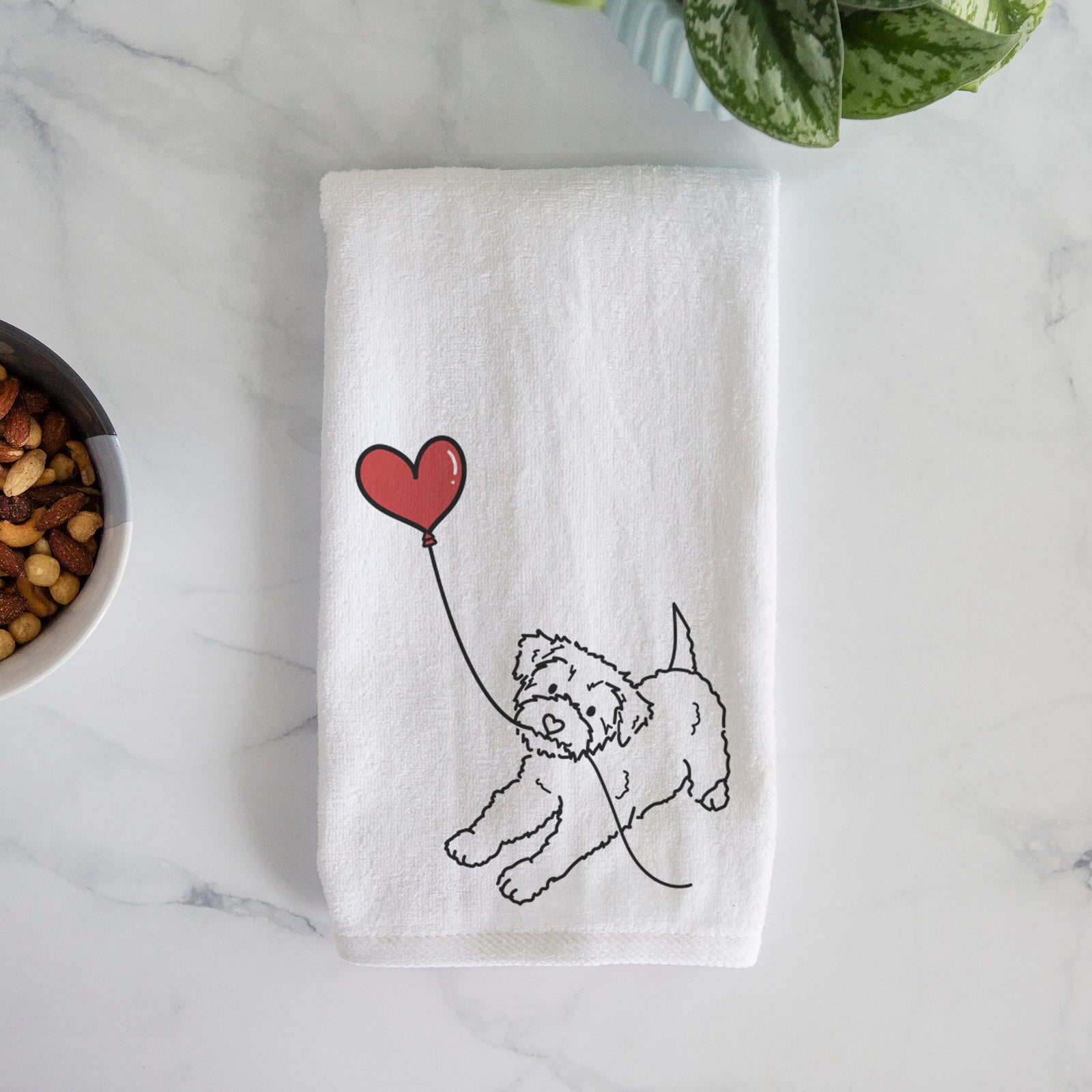 Minimalist line drawing of a Yorkiepoo Heart String holding a heart balloon on a decorative hand towel