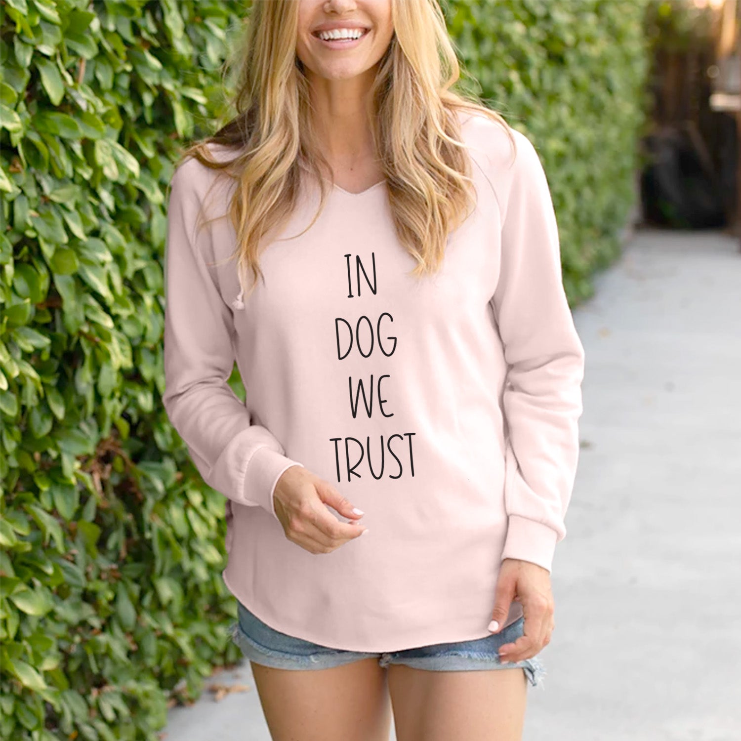 'In Dog We Trust' design on a Blush Cali Wave Hooded Sweatshirt, lifestyle photo