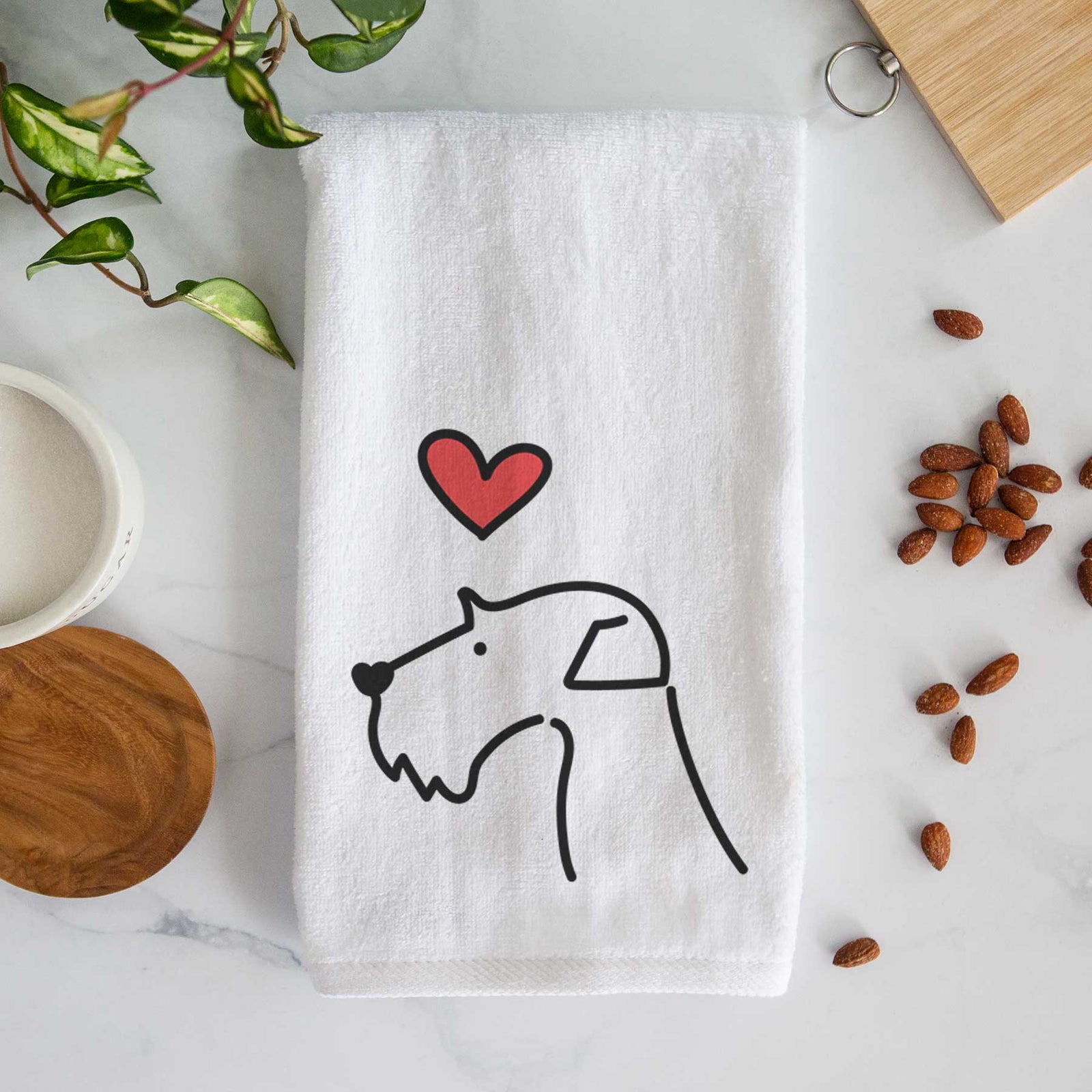 Minimalist line drawing of an Airedale Terrier with a red heart on a decorative hand towel