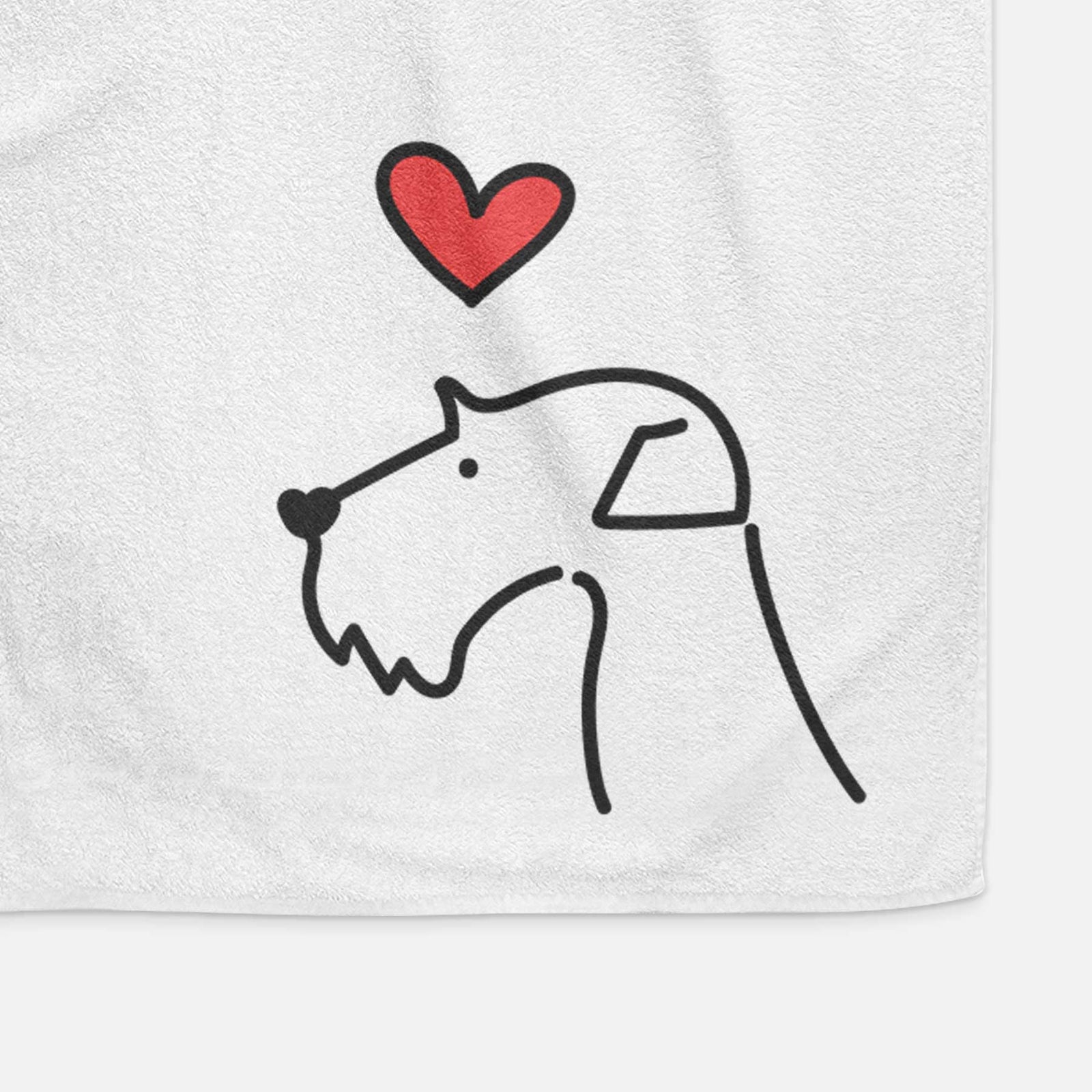 Minimalist line drawing of an Airedale Terrier with a red heart on a decorative hand towel