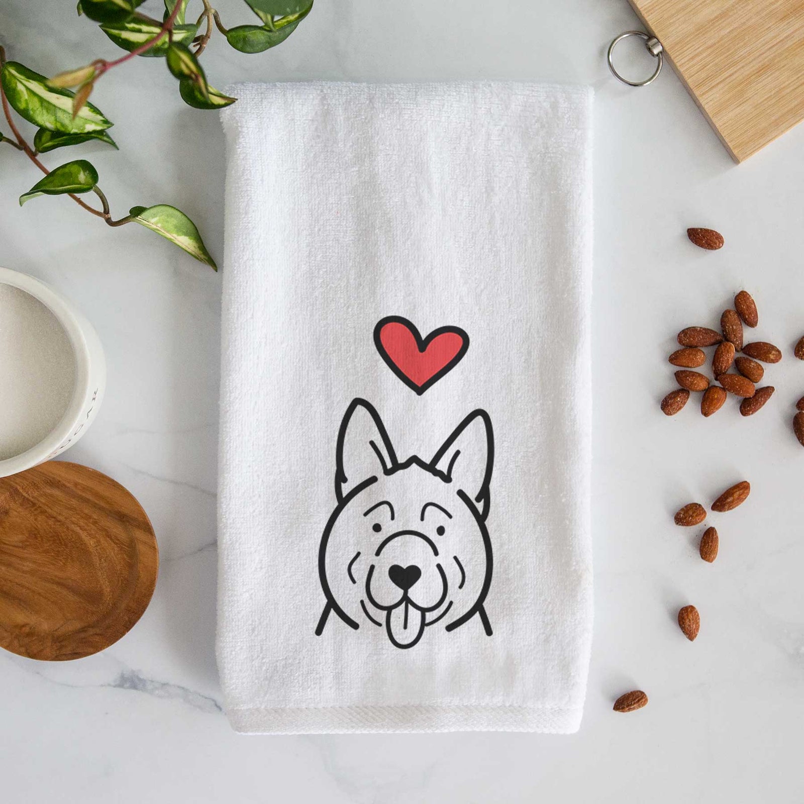 Minimalist line drawing of an Akita with a red heart on a decorative hand towel